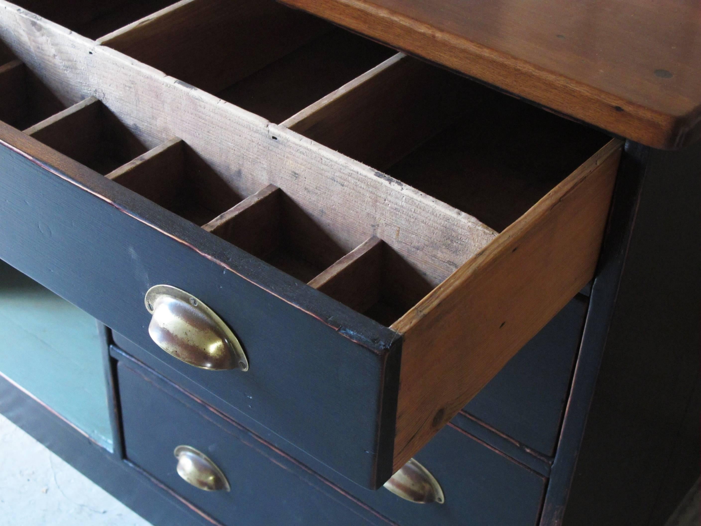 Painted pine base with stained oak top and brass pull handles. Some restoration work done, particularly to top as this piece of furniture had spent the last few years being used as a workbench.
