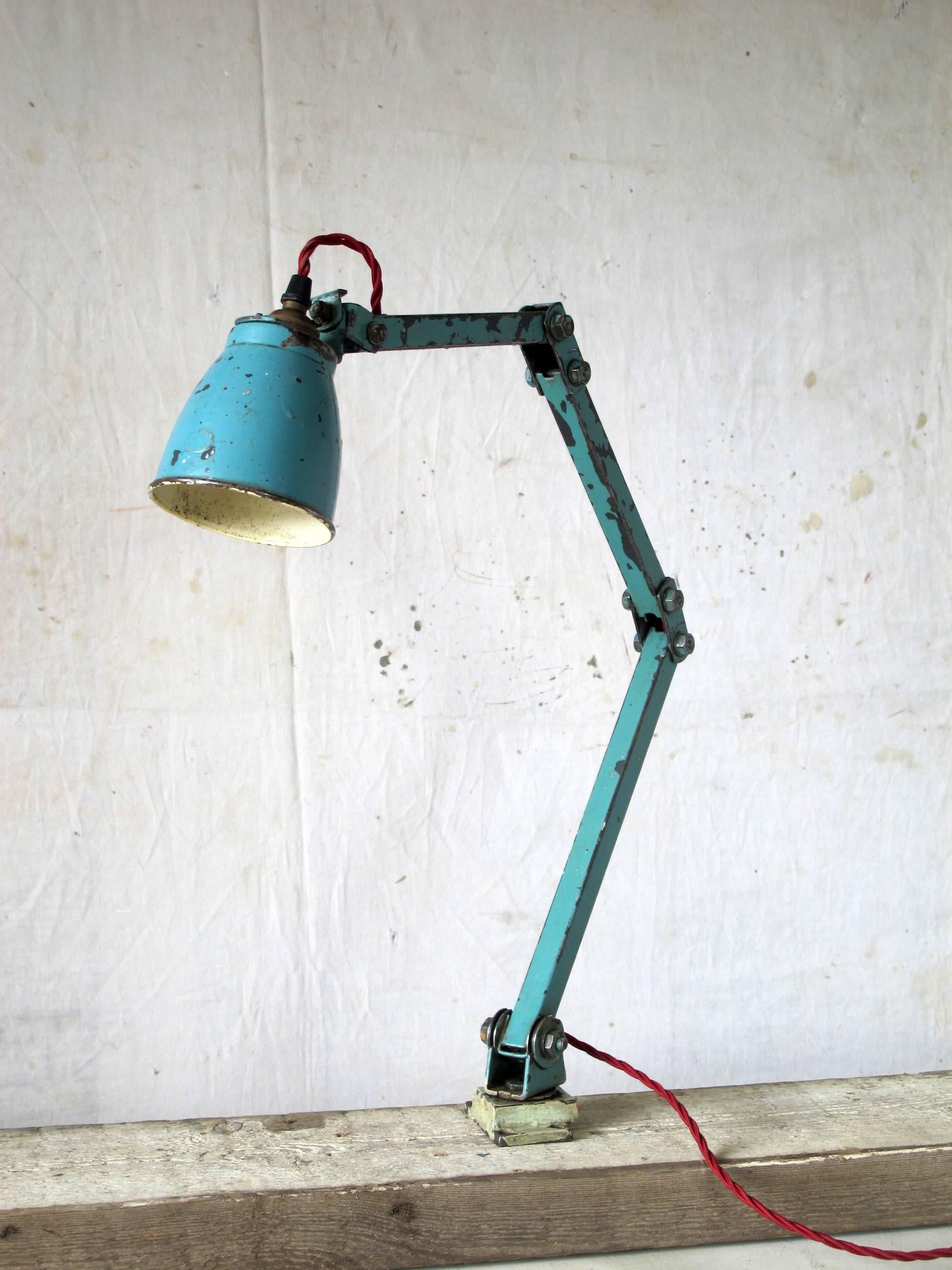 Articulated steel arms, with a pressed steel shade. Later 'turquoise' paint finish. Rewired and tested. Can be wall or bench-mounted.