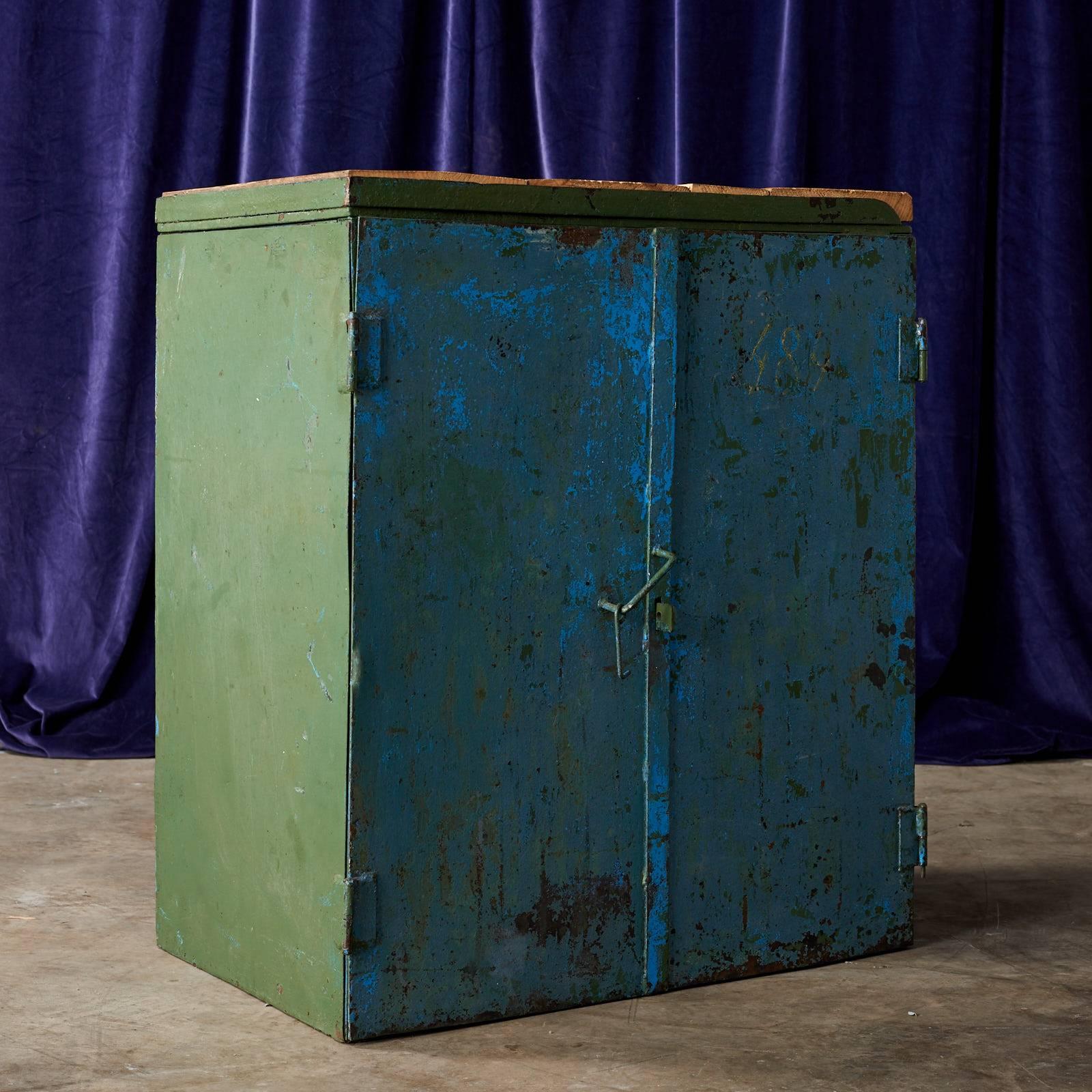 An Industrial indigo cabinet with reclaimed scaffold board top and latch.
