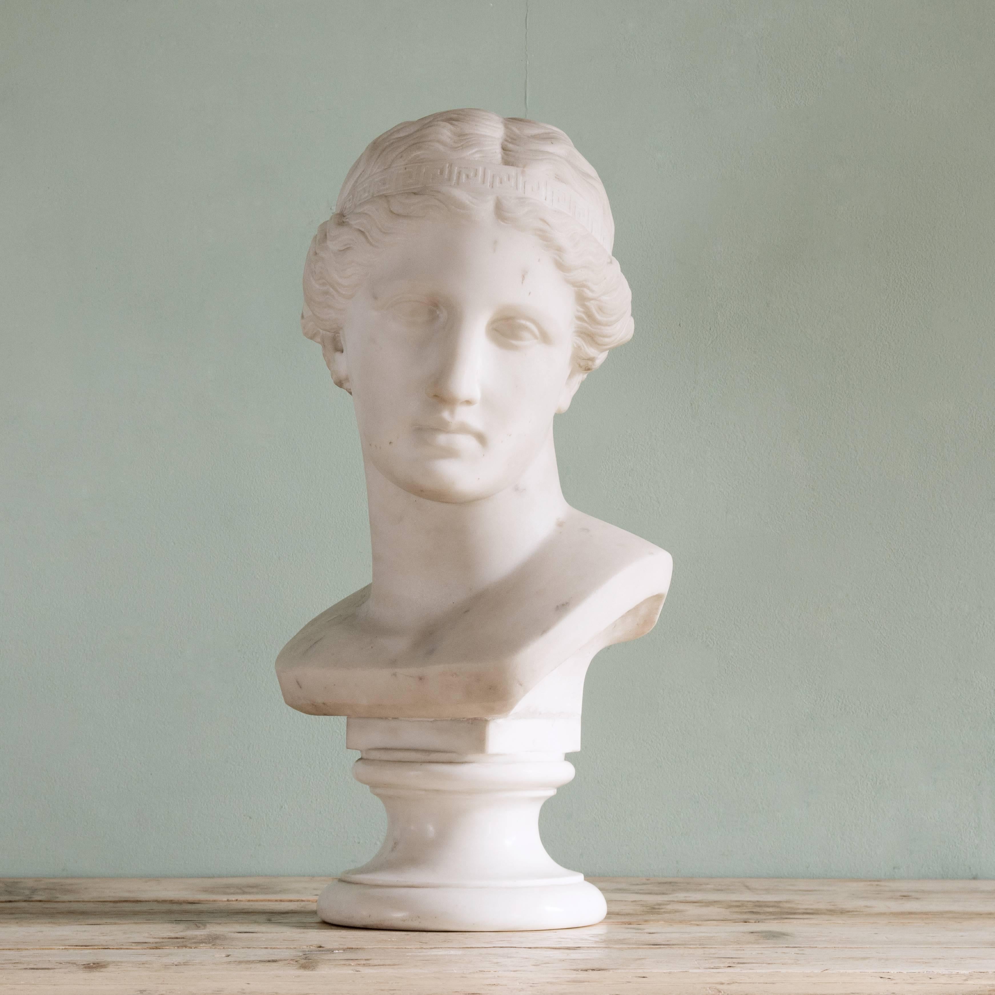 A Carrara marble portrait bust of Venus, 19h century, with head turned to sinister on turned socle base, signed 'Hugget af B. Bergstien',

Dimensions: 52.5cm (20¾