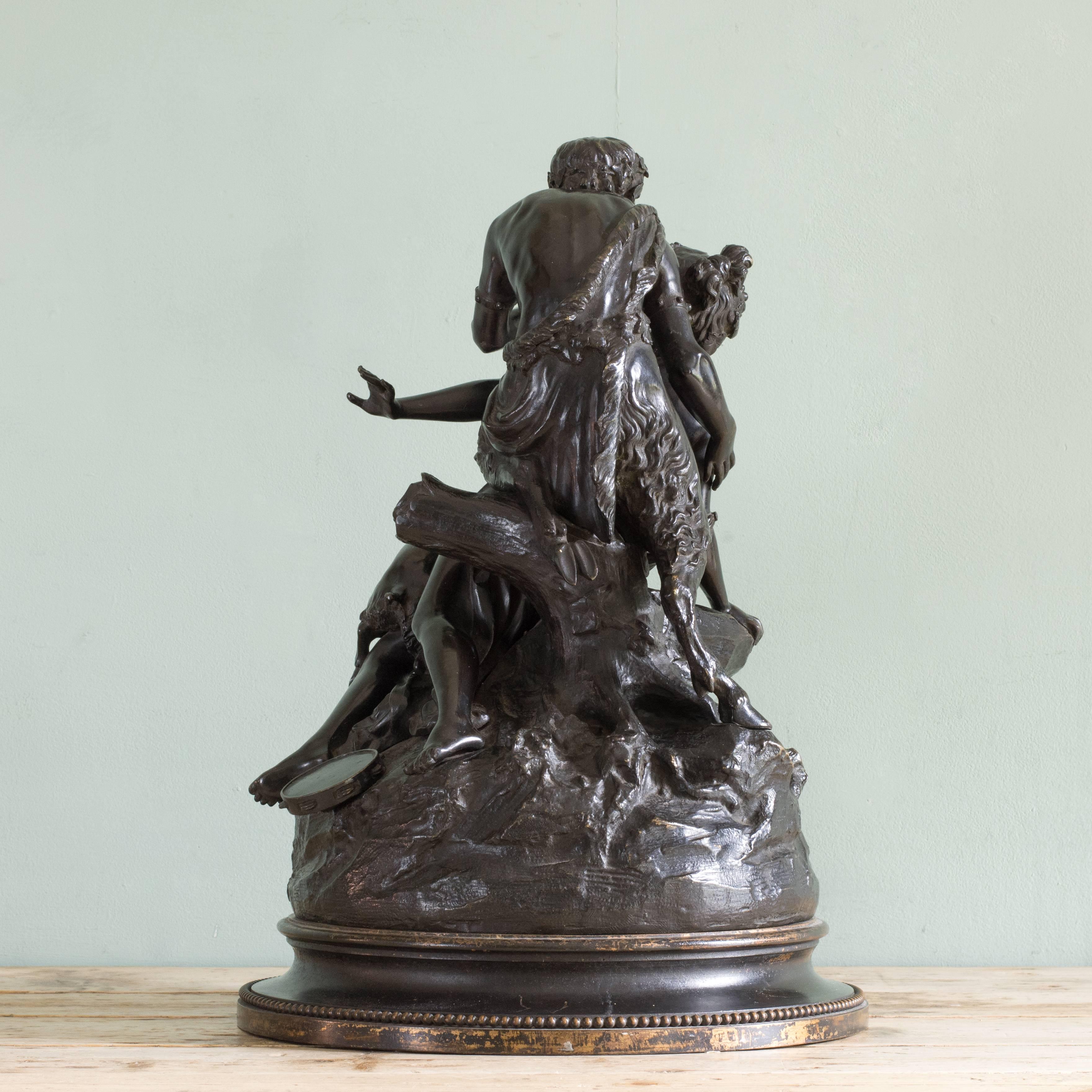 A late 19th century bronze of a Nymph, Satyr and Putti, after Claude Michel 'Clodion', on circular base, circa 1875, signed Clodion.

Dimensions: 53.5cm (21