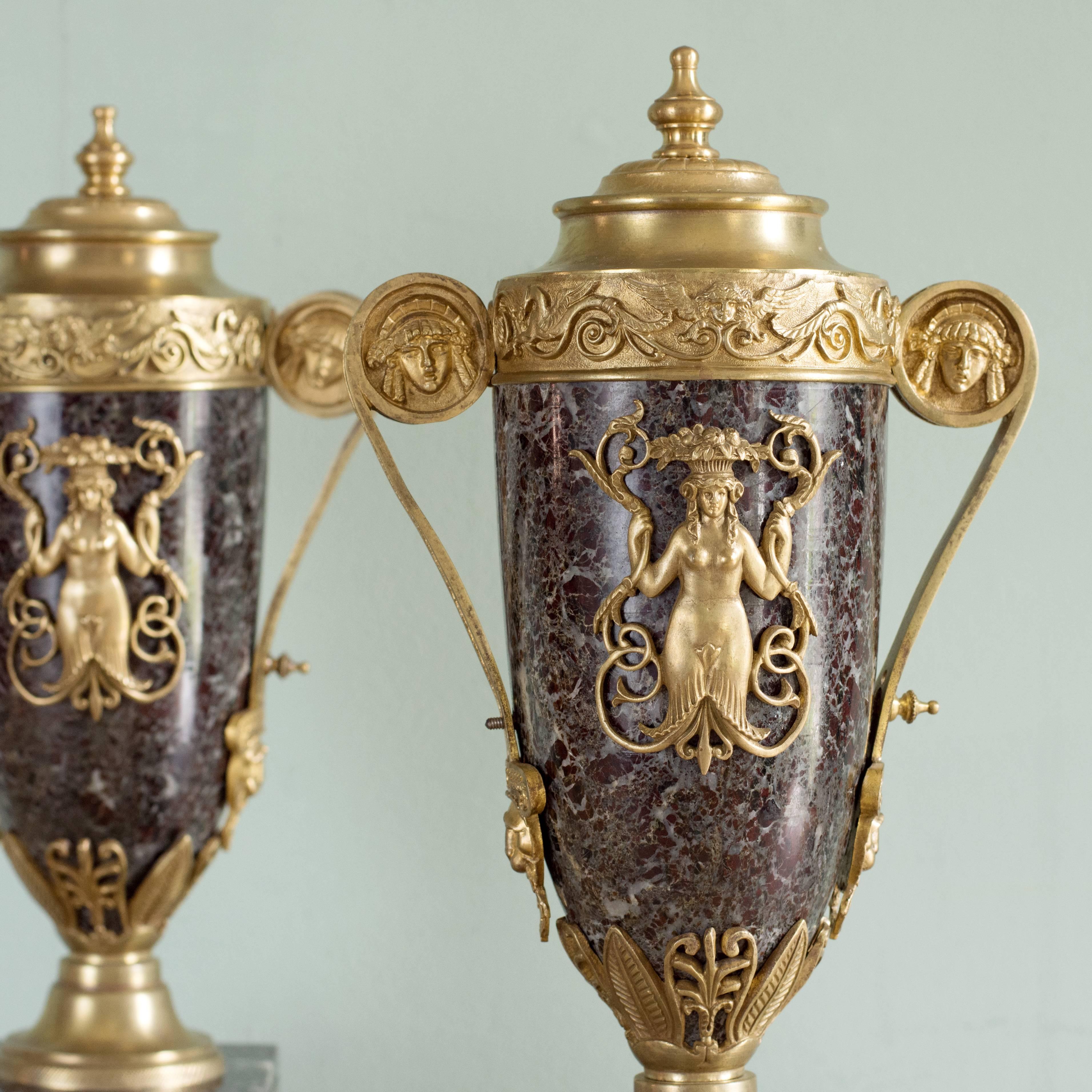A pair of neoclassical style cassolettes, early 20th century, gilt bronze-mounted on variegated marble.

Dimensions: 46cm (18