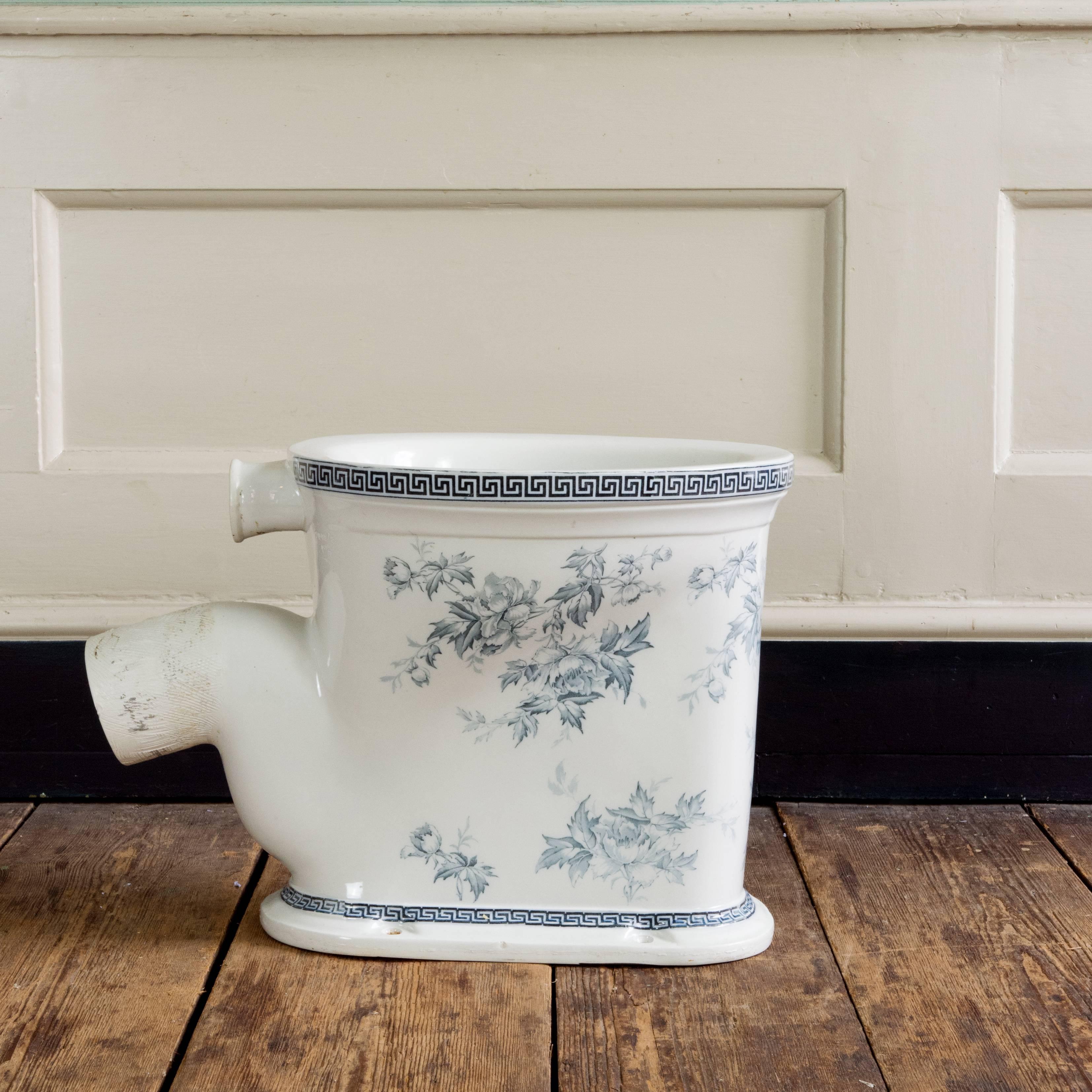 An Edwardian blue transfer printed toilet pan, 'The Velox Washdown Closet,'
the rim and base with Greek key border, the pedestal and interior with floral decoration, with P-trap outlet.

Dimensions: 40cm (15¾