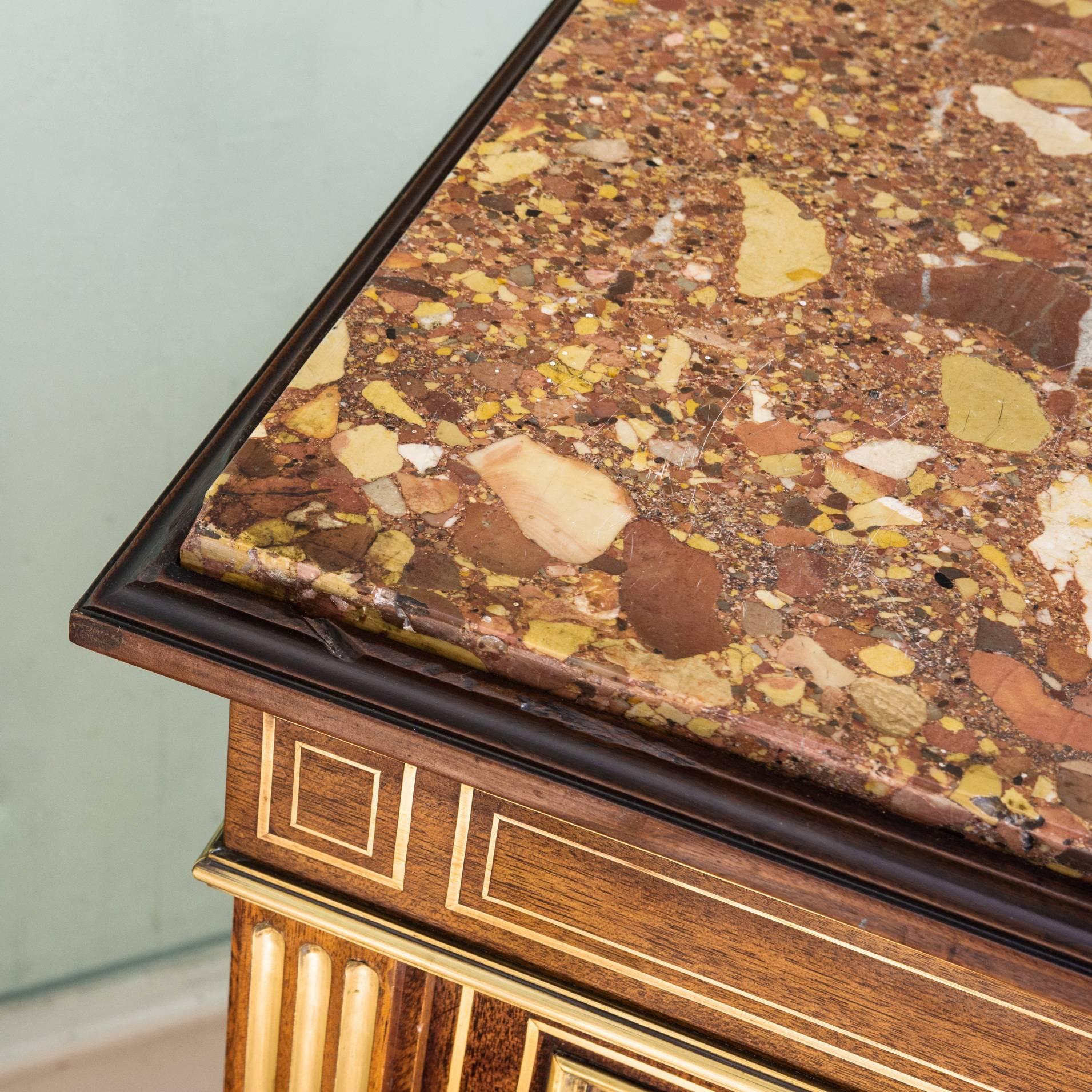 A pair of French mahogany vitrines, circa 1900, the Breche d'Alep marble-top above bodies inlaid with brass stringing and glazed doors enclosing shelving flanked by pilasters with brass fluting, on turned feet. Slight variance in colour, some very