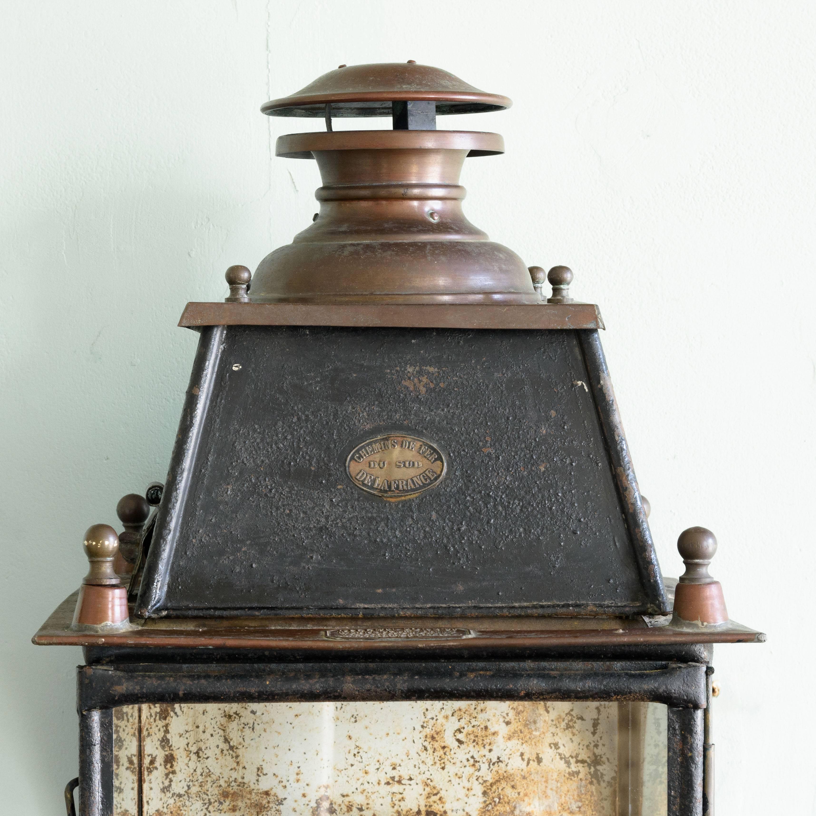19th century French wall lantern, the shaped funnel lid above roof with finials leading to glazed body with single light fitment.