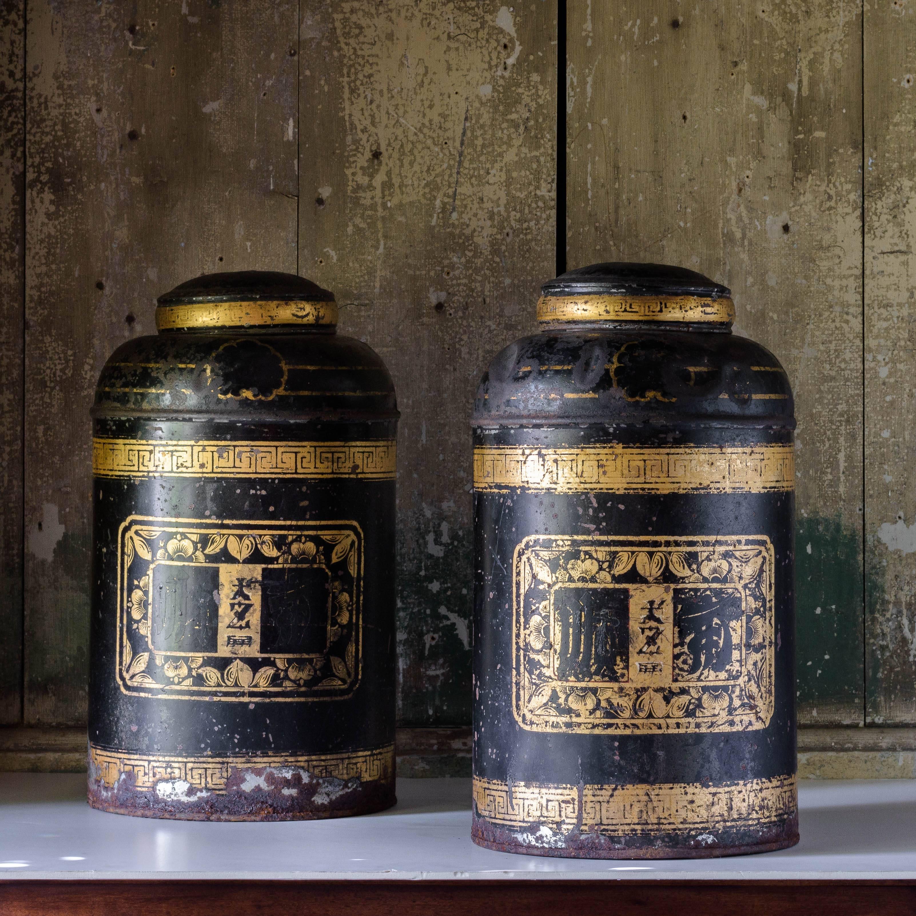 Late 19th century toleware tea canisters in the chinoiserie taste, with all-over gilt decoration.