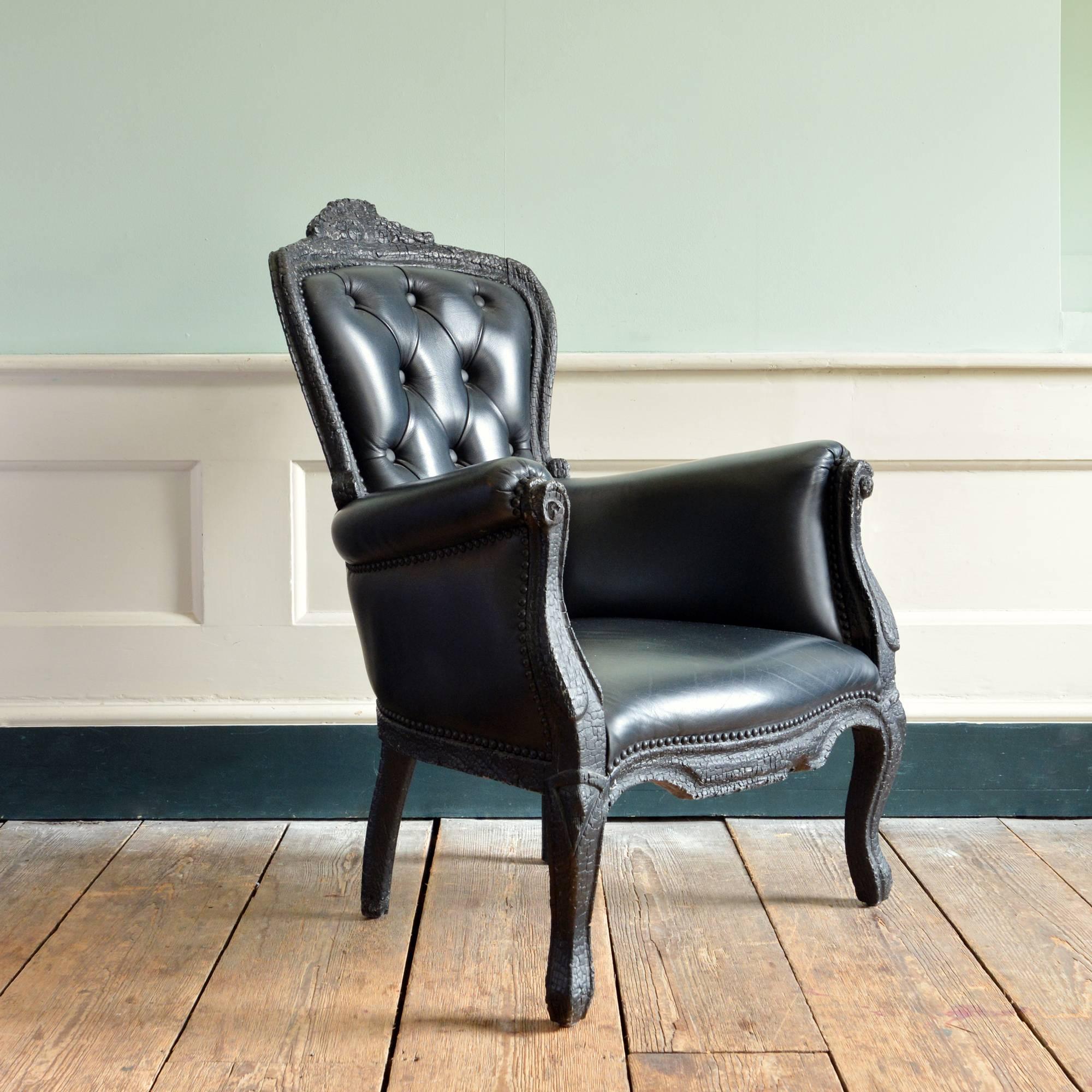 A 'Smoke' armchair, designed by Maarten Baas for Moooi to a French Rococo design, made from burnt solid wood with epoxy resin and leather upholstery. 

Measures: 102 cm (40¼