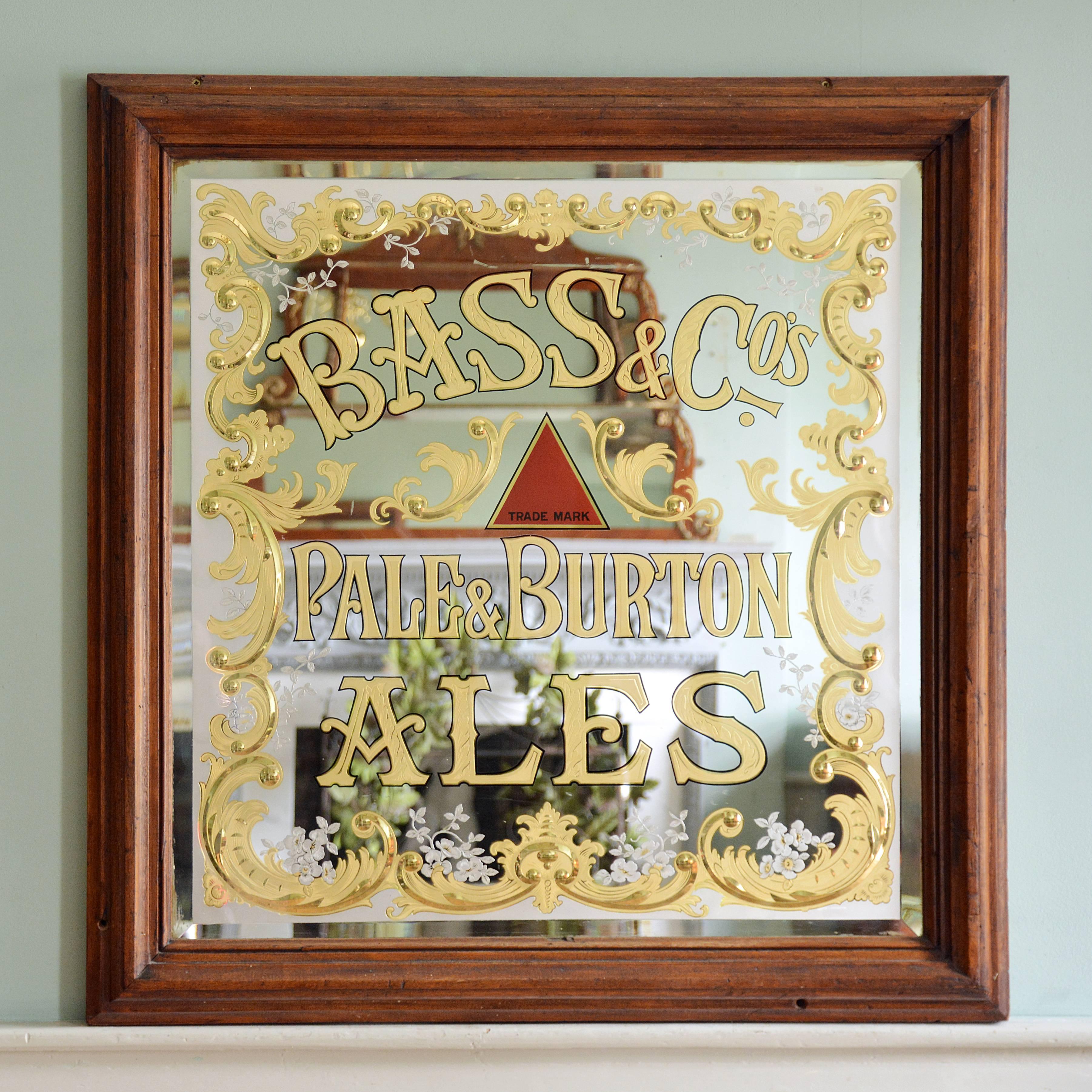 A 'Bass & Co' pub mirror, with gilded and cut C-scroll and foliate border, in reverse moulded frame.

Available to view at Brunswick House, London.

Measures: Height 107.5cm, width 105cm, depth 7cm.
 