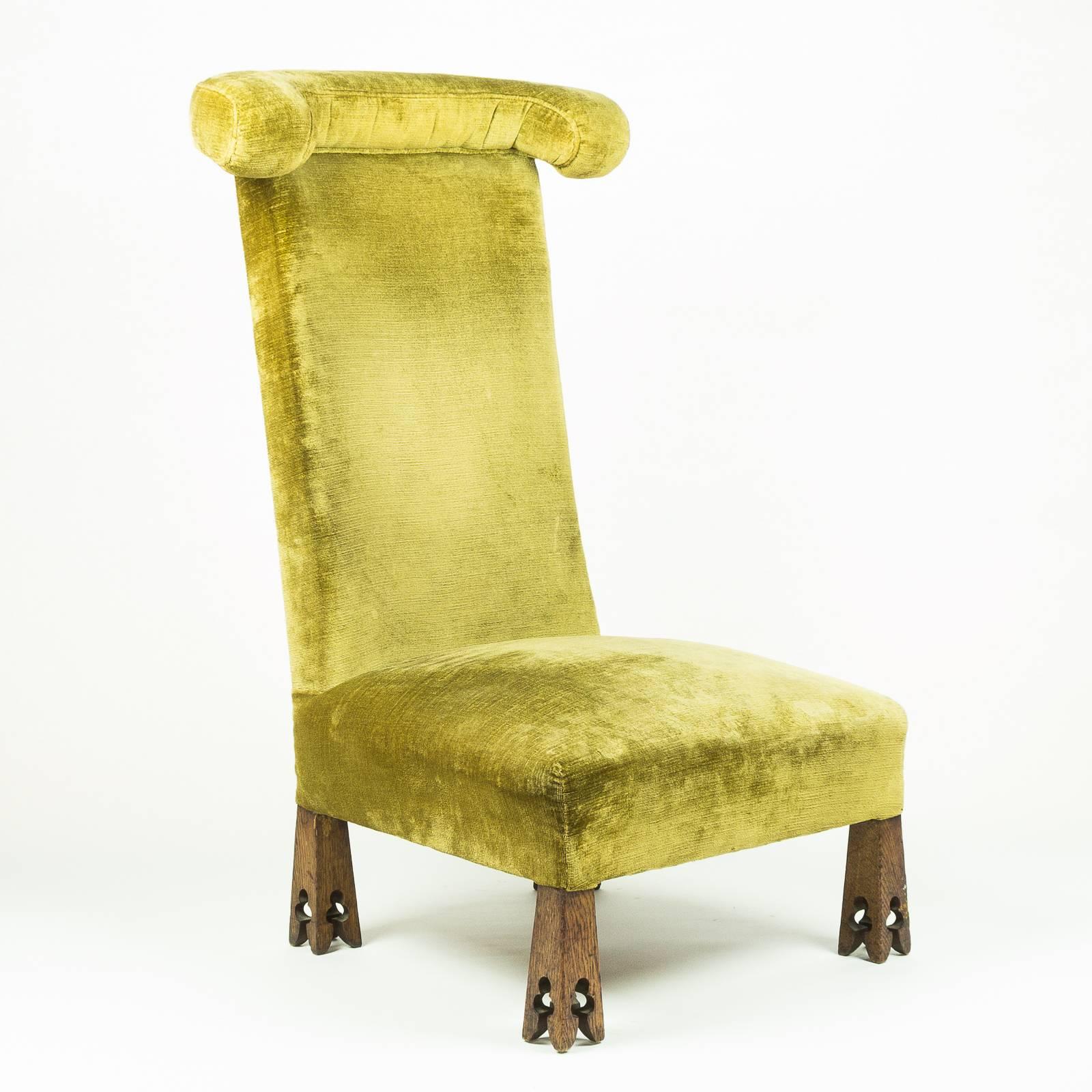 An Arts and Crafts 'Prie Dieu' chair with velvet upholstery and carved oak feet, Probably retailed through Morris & Co. 