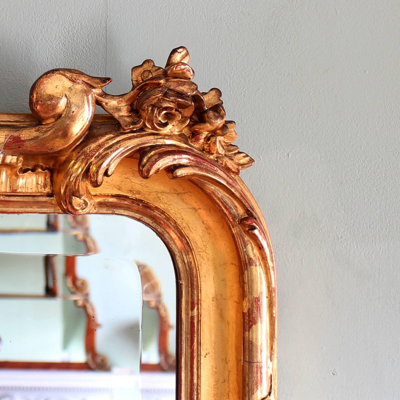 A nineteenth century French giltwood mirror, the shaped and bevelled plate surrounded by frame decorated with foliage and scrolls in the Rococo taste.

Available to view at Brunswick House.

Dimensions:
155.5 cm high x 103 cm wide x 13.5 cm deep