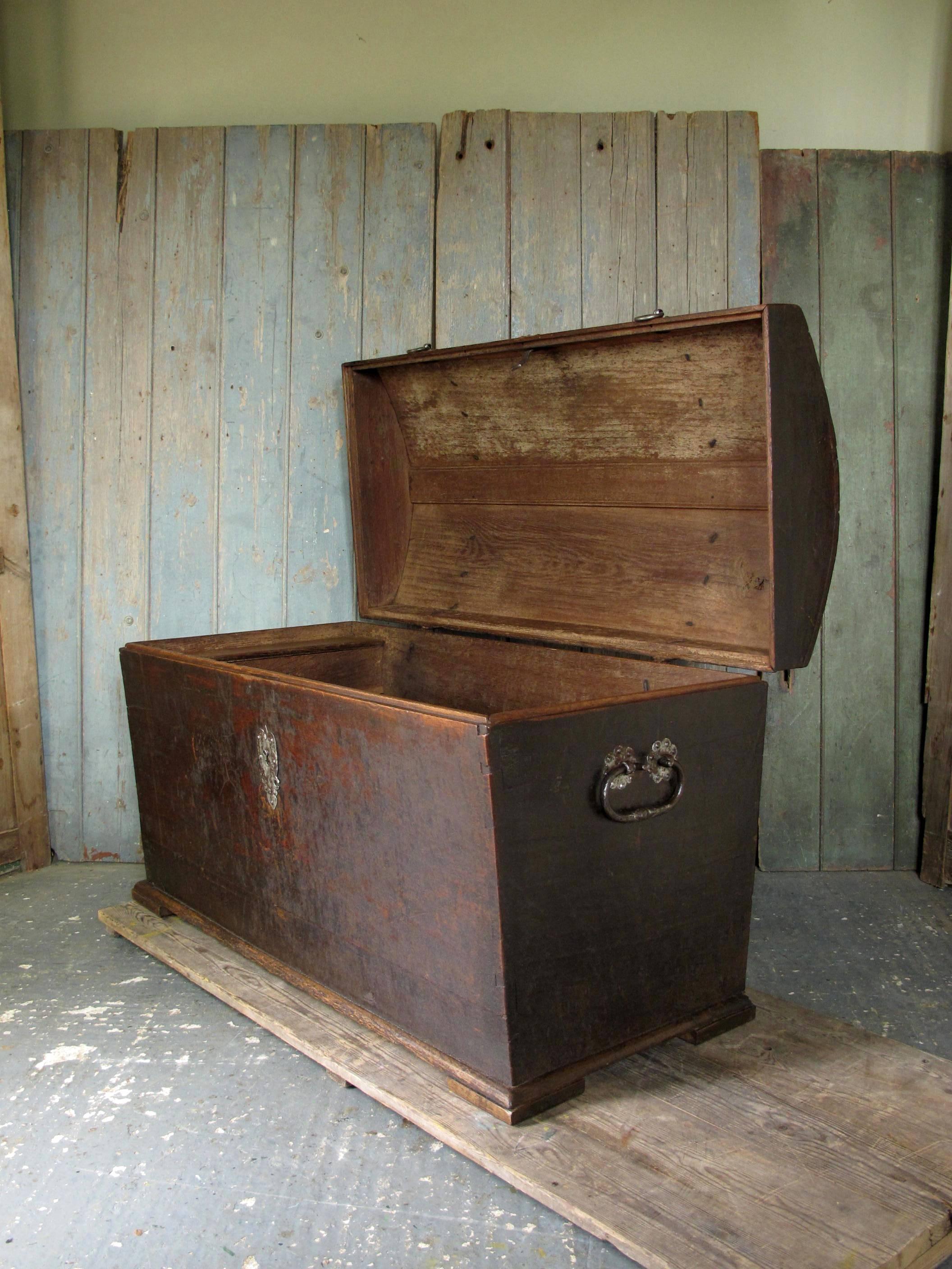 With wrought iron straphinges and carry handles. 'Tinned' steel escutcheon and fittings. Internal candle box with lid. Treated for woodworm, and waxed externally. Dating from the 18th century, with later repair to corner of lid.