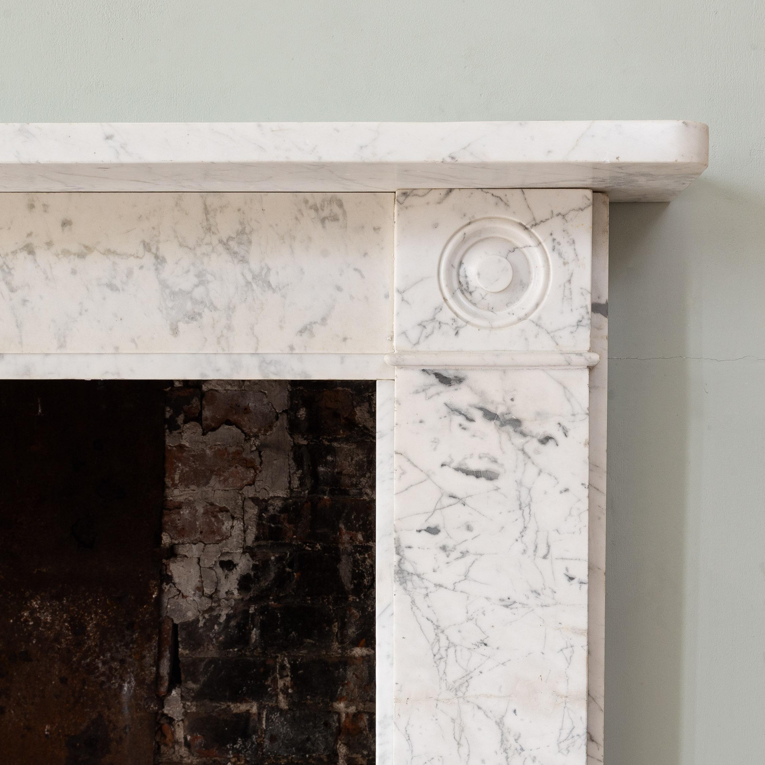A nineteenth century antique Regency period Carrara marble chimneypiece
with turned bull's eye roundels to the corner blocks. Restored and ready to install and use.

Dimensions:	113.5cm (44¾