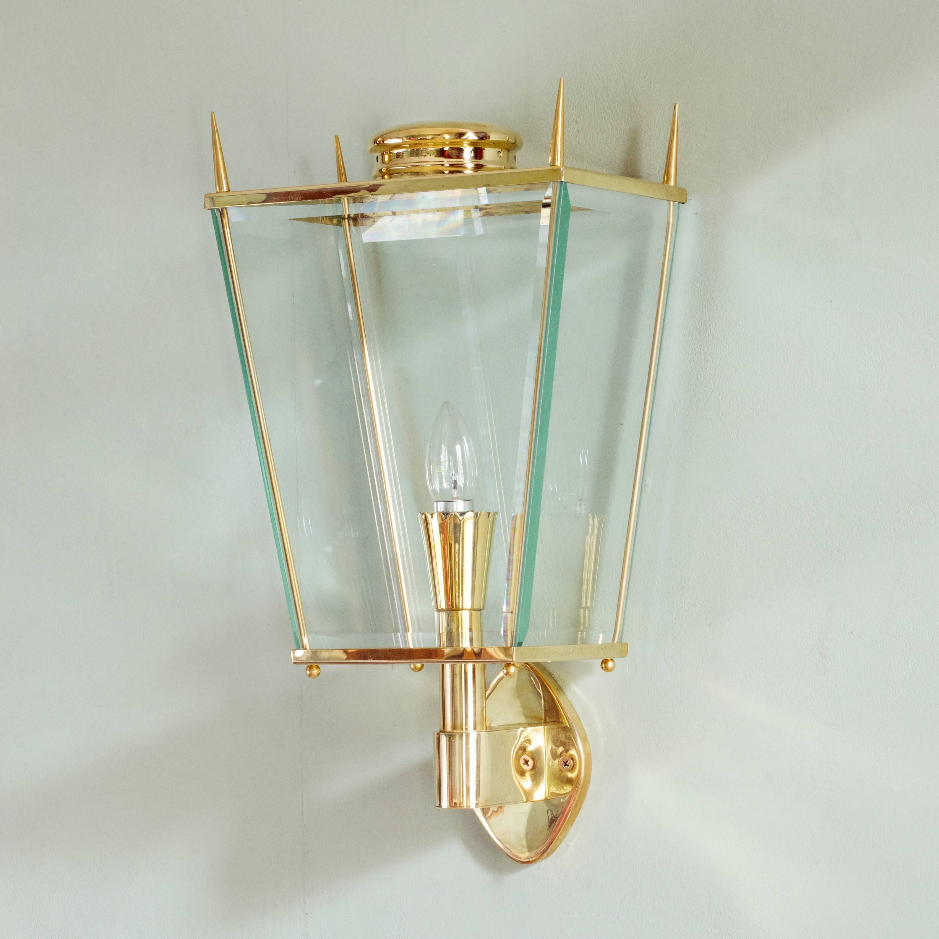 Mid-Century style brass wall lanterns, made by Lassco in the Italian 1960s style, the tapered body with bevelled glazing. Suitable for indoor and covered outdoor use. Handmade in England to order, lead time usually six weeks.

Dimensions: 49.5 cm