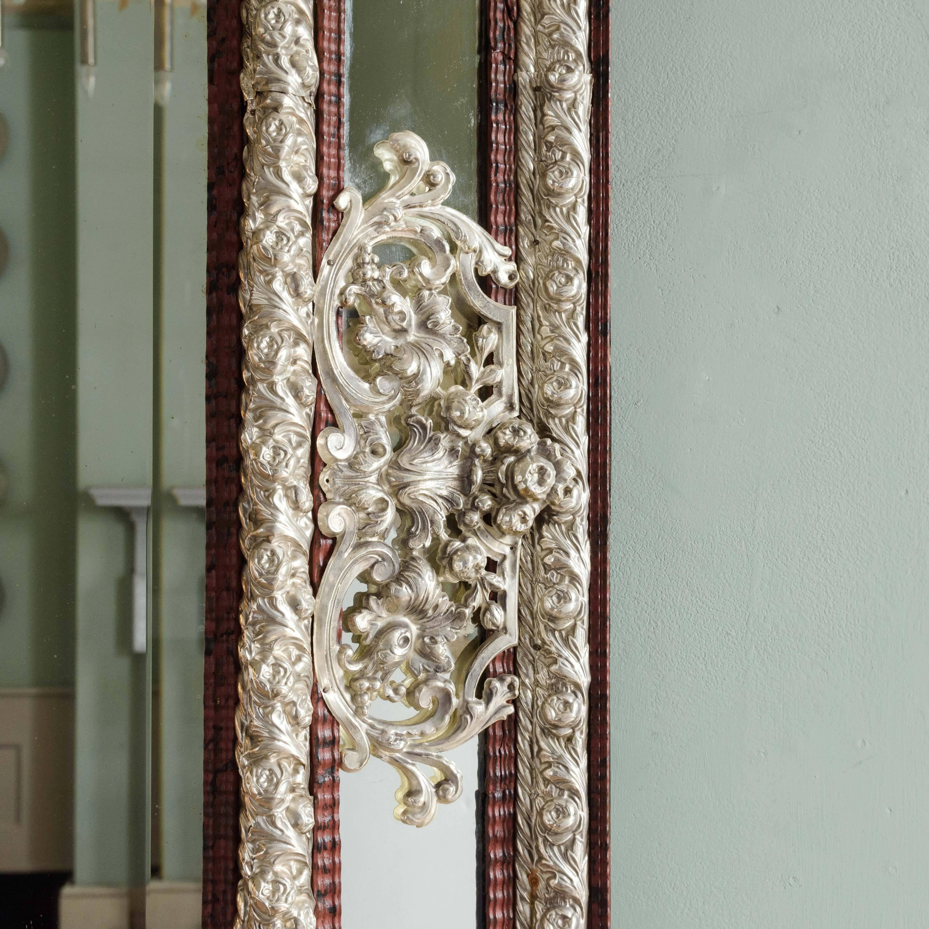 17th century style Dutch mirror, the silvered repousse metalwork and faux tortoiseshell ripple moulded frame surrounding central bevelled plate.

Dimensions: 158cm (62¼