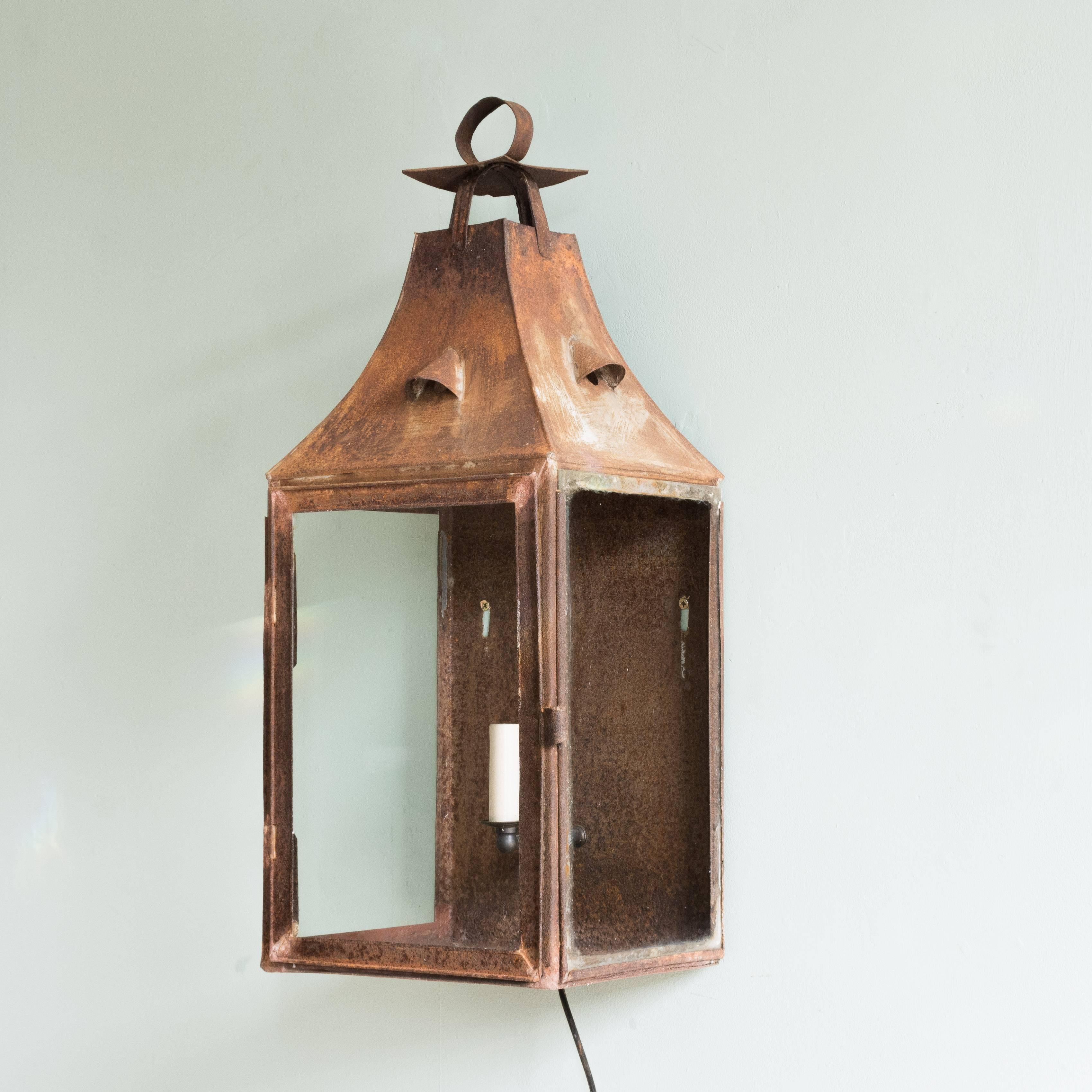French 19th century wall lantern, the steel body with pagoda top and three-quarter glazed body enclosing rear mounted single light fitting.