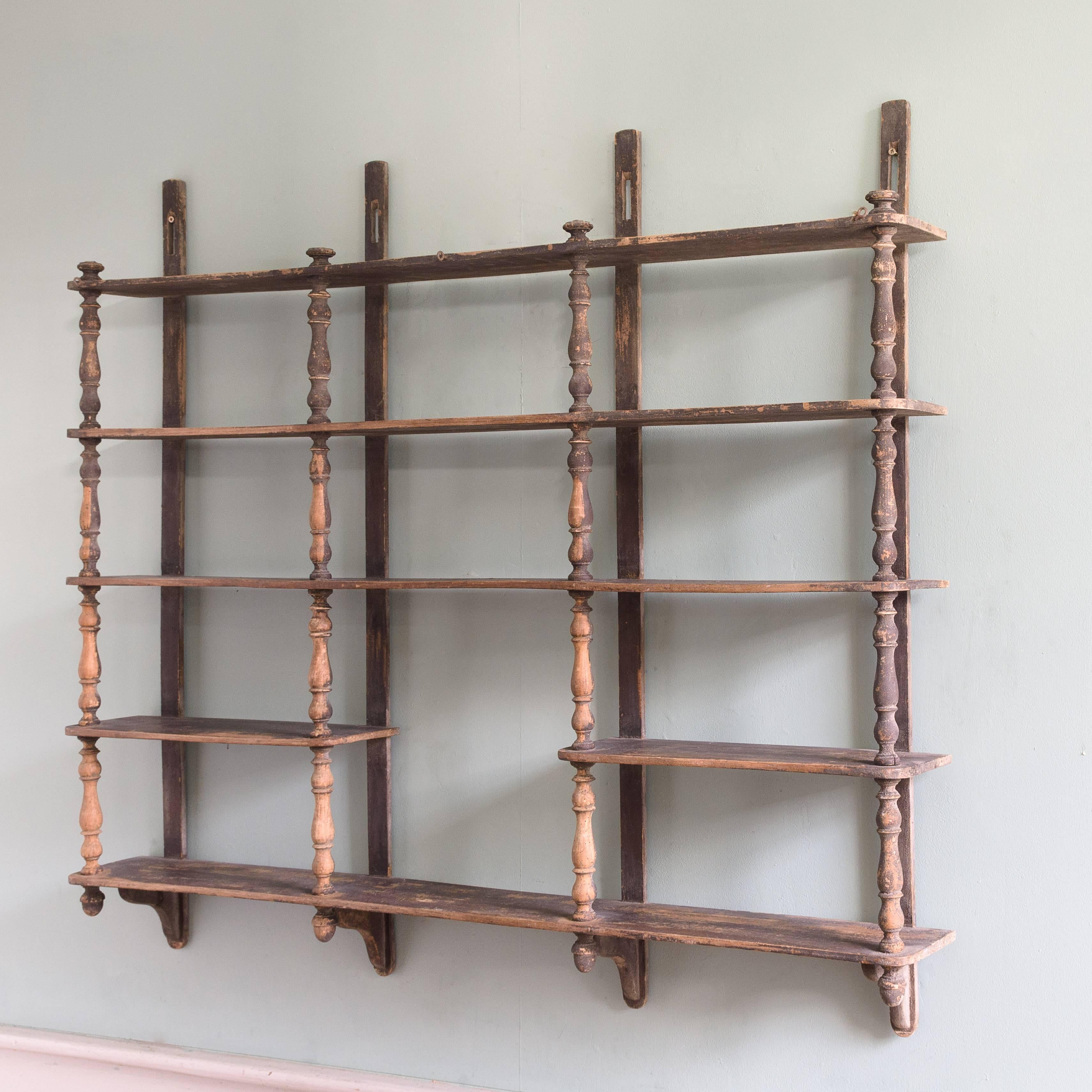 A set of 19th century French wall shelves, with turned upright supports, retaining historic surface finish, circa 1850-1870.