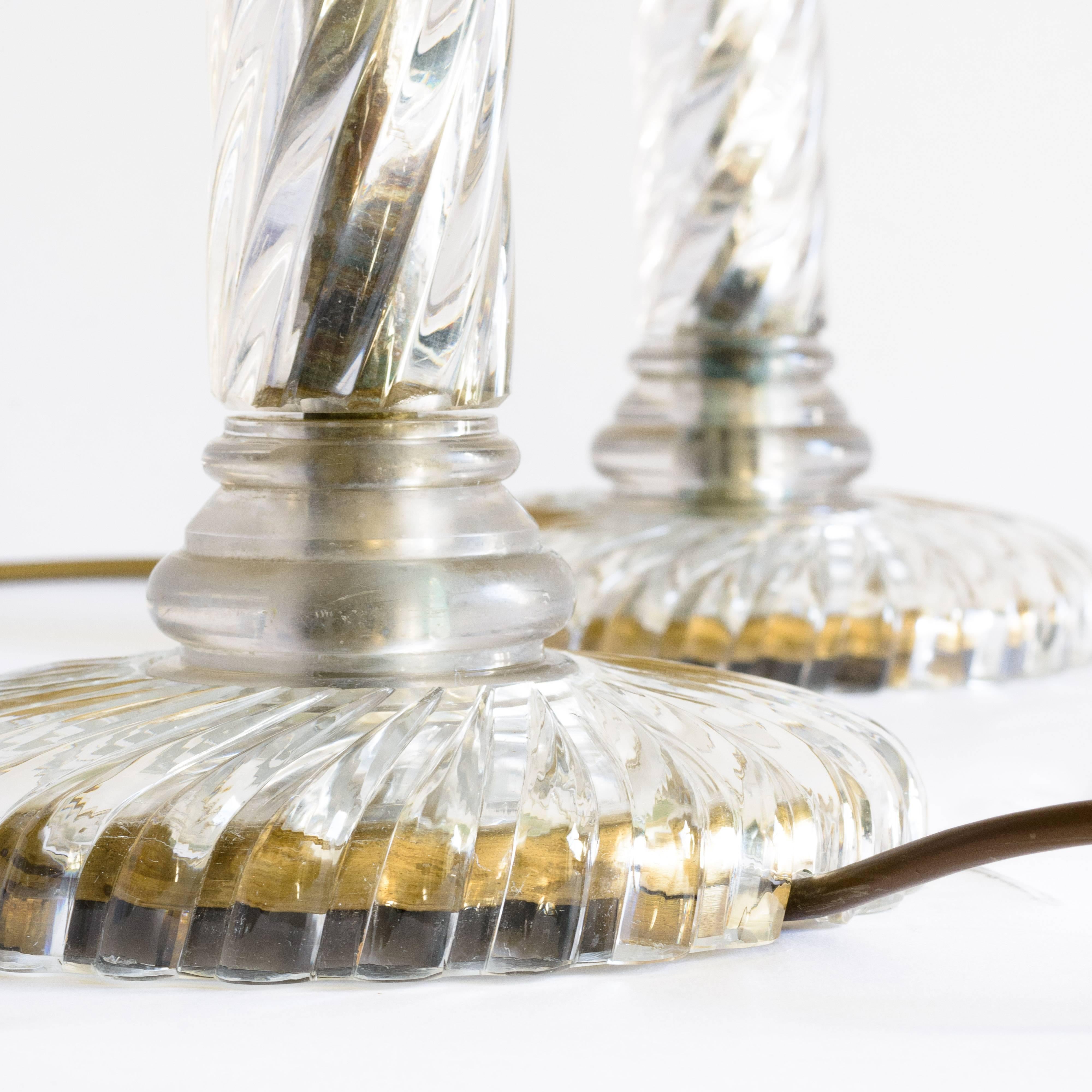 Pair of wrythen stemmed glass table lamps, 20th century, with gadrooned bases.