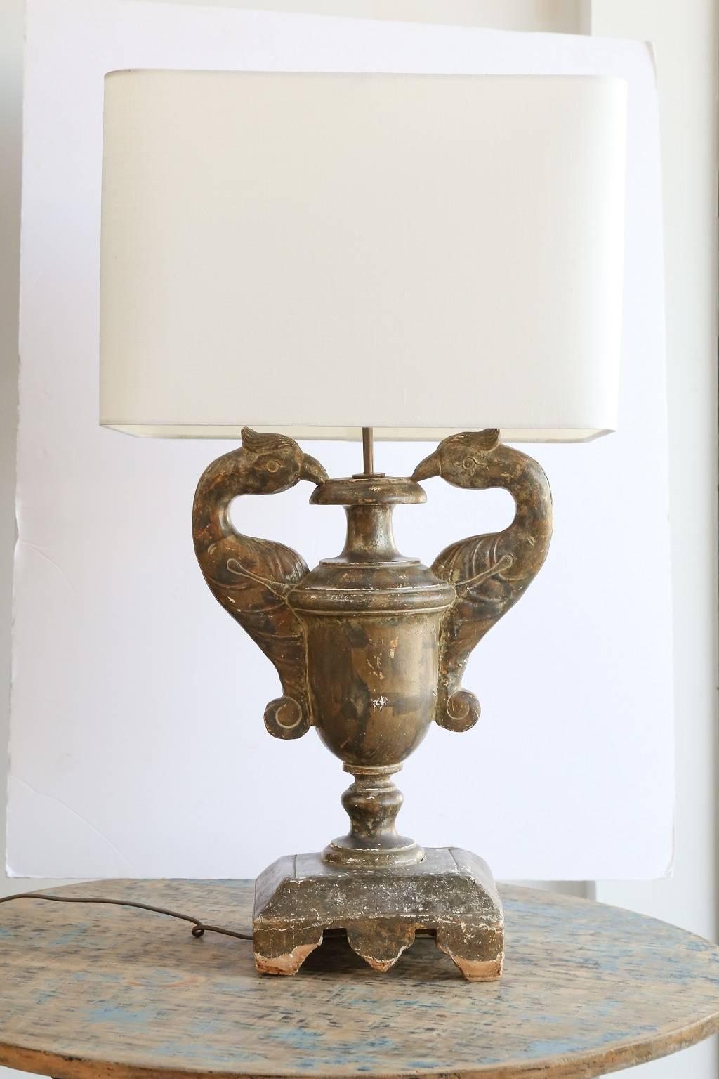 18th century gilded carved wood urn-shape fragment newly wired as custom table lamp with rolled edge linen shade.