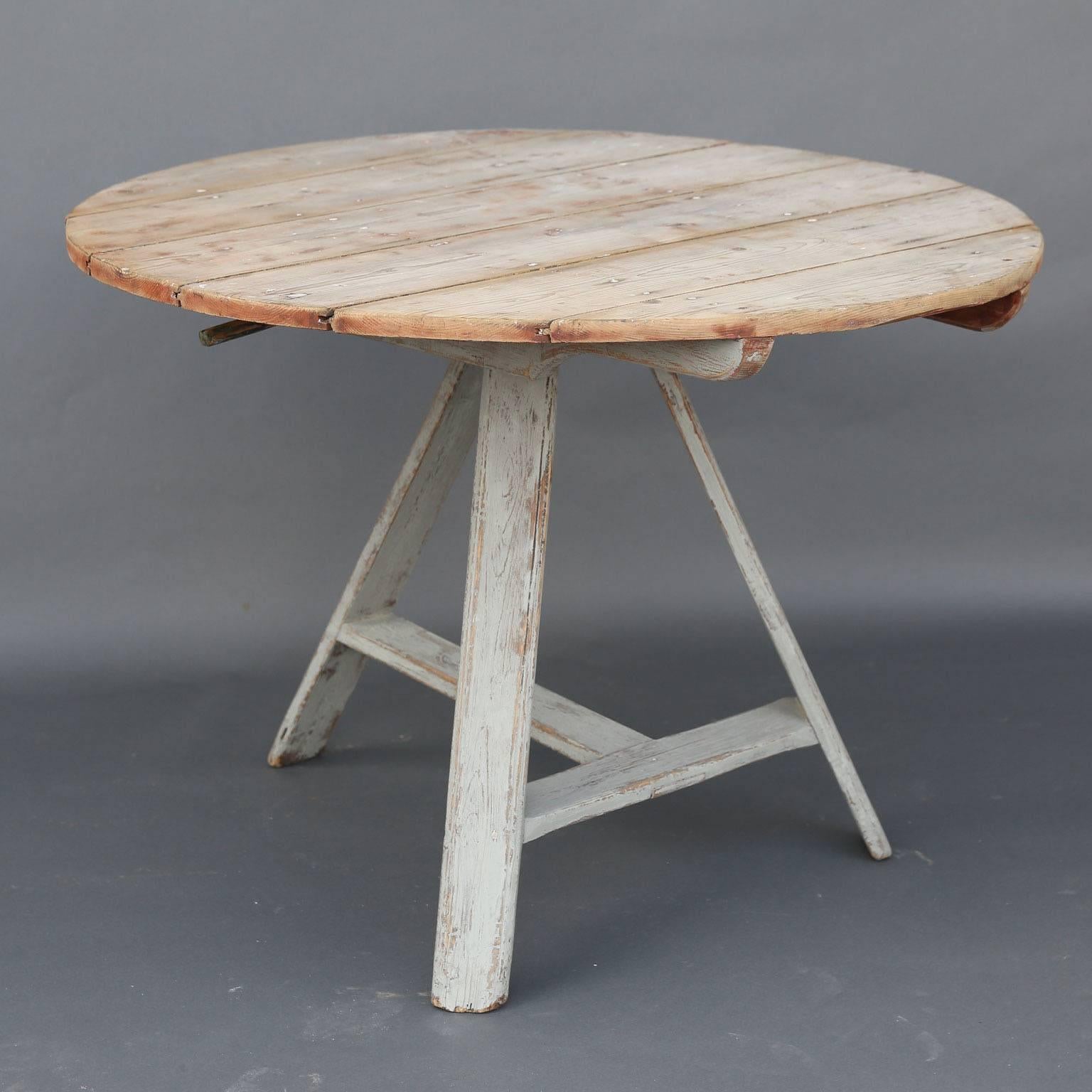 Dutch tilt-top table with painted tripod leg base and scrubbed round wood top, circa 1900.