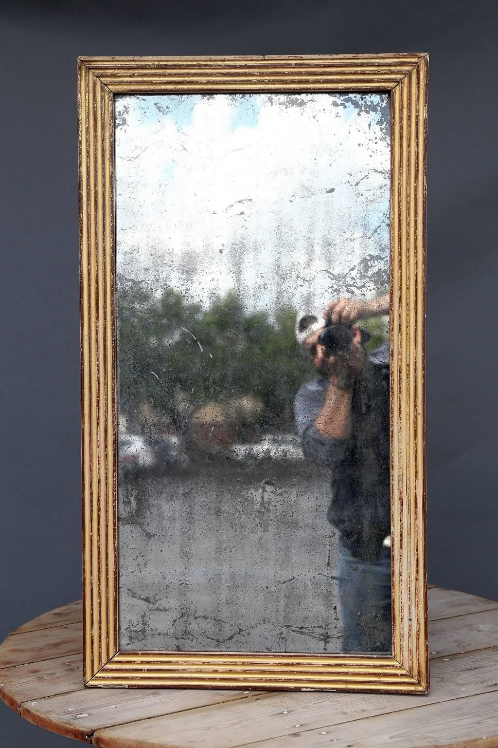 Late 18th century bois doré mirror, Classic fluted frame and original mirror with a moderate amount of spotting from age.