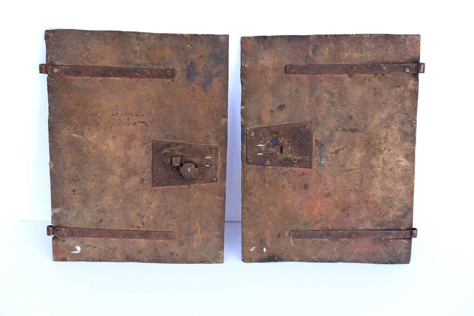Pair of early oil on copper paintings featuring scenes displaying saints, (circa 1680-1700). Copper panels originally served as tabernacle doors. Continental European in origin, probably Italian, with writing on reverse. Sold together as a pair