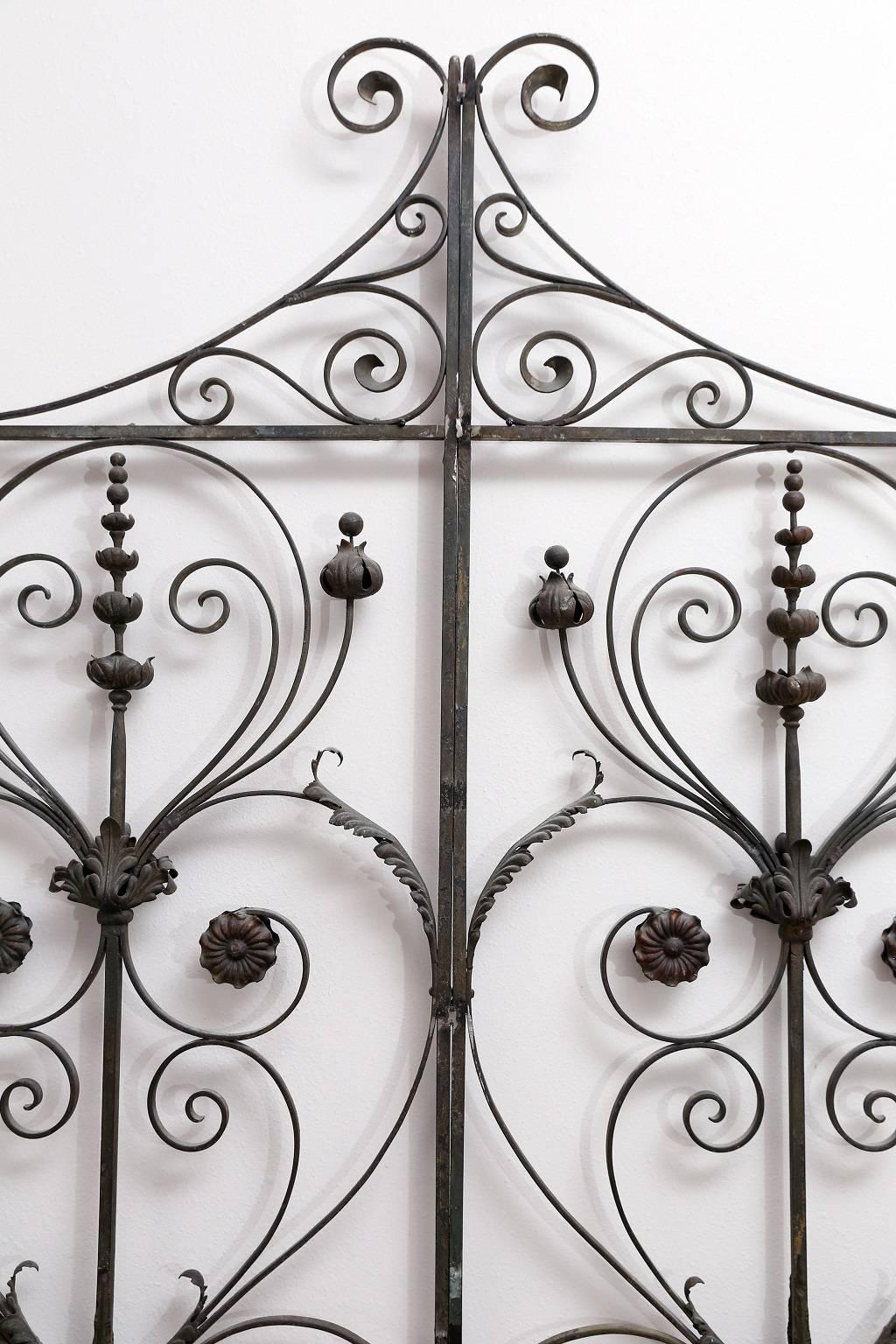 Pair of fine, high quality 19th century wrought iron gates, currently welded together as a queen-sized headboard. Sold together as a headboard, but the gates can be separated and restored as a pair of functional gates.