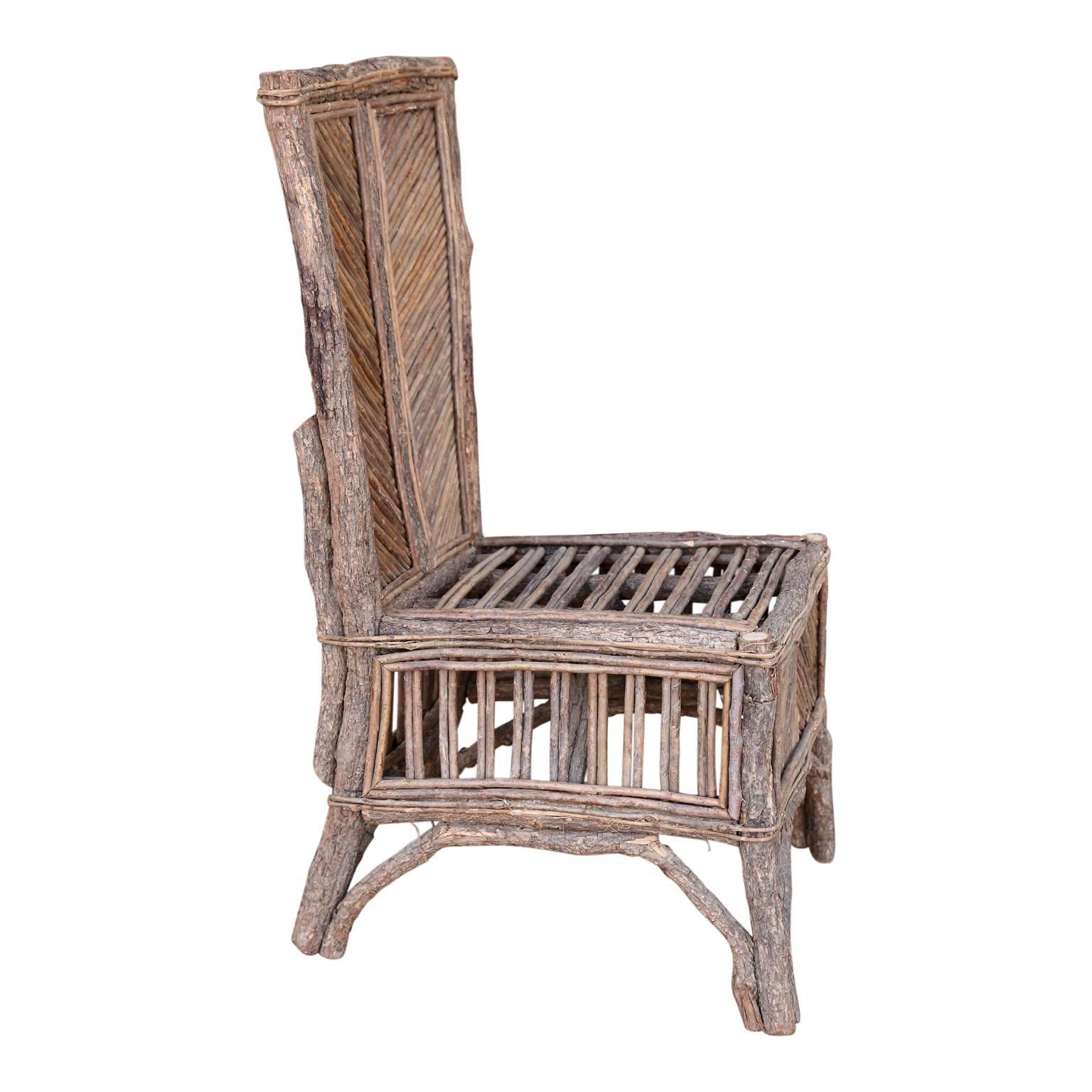 Vintage French Folk Art chair created from sticks, twigs and branches; very sturdy and decorative.