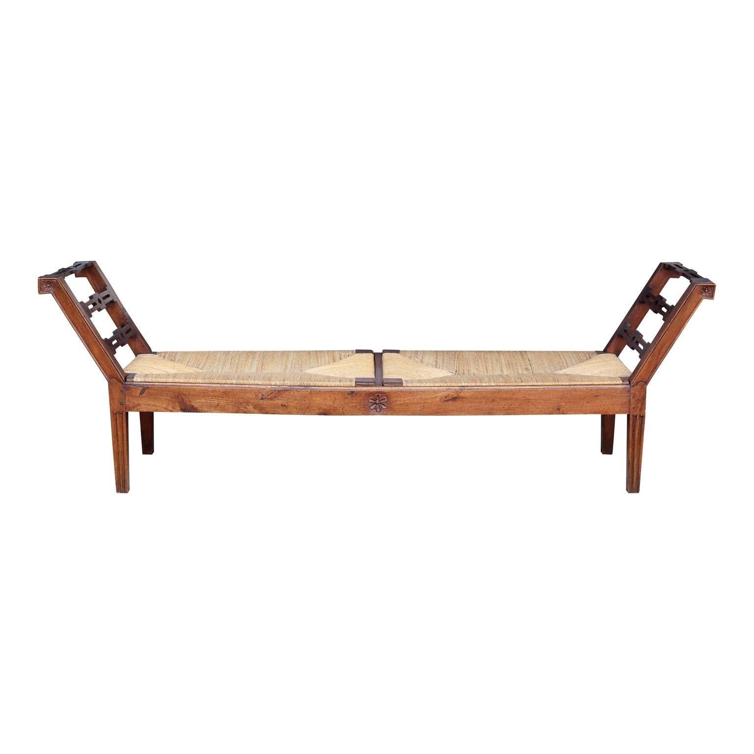Early 19th century rush-seat bench from Tuscany, in walnut and oak with carved flower motif.