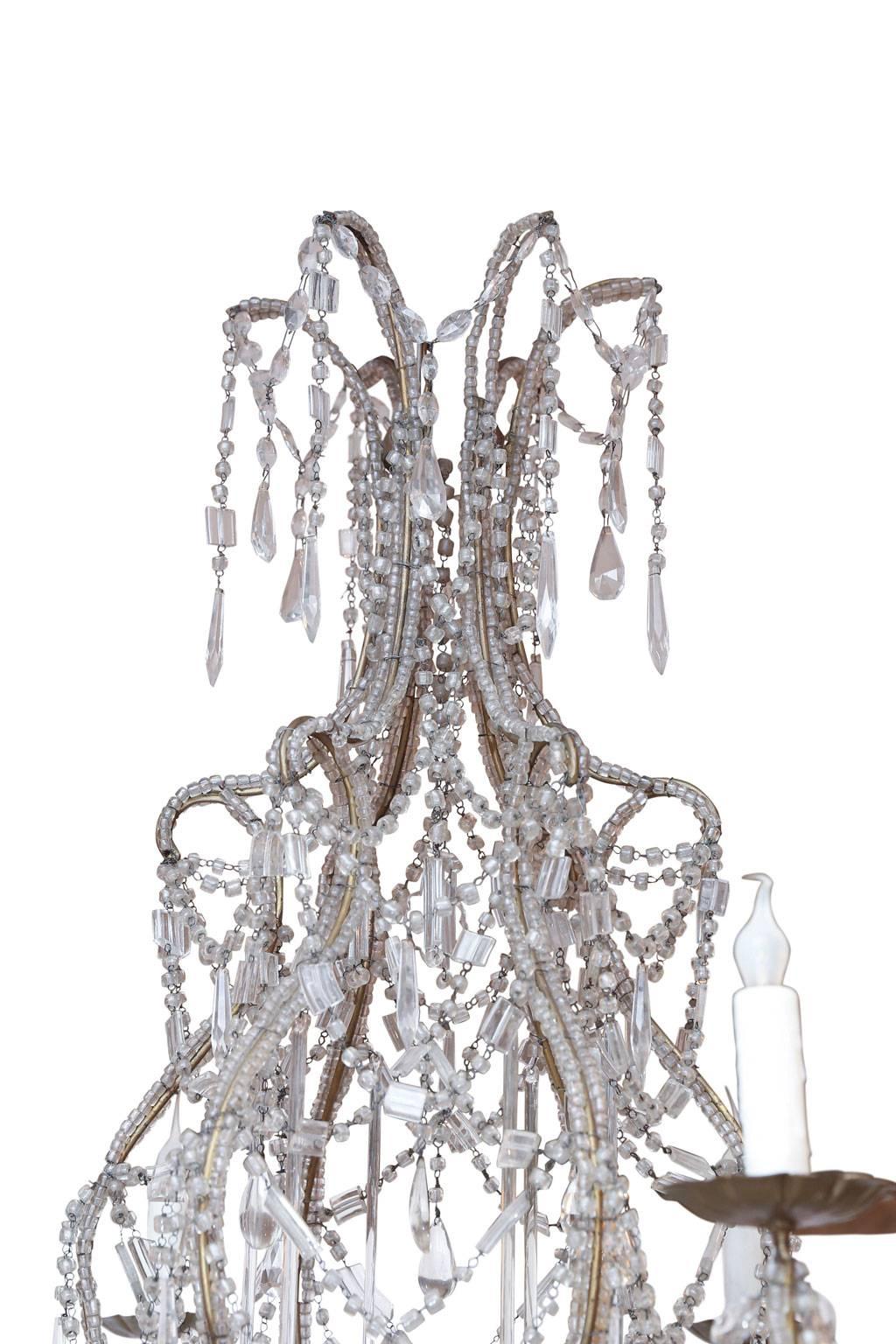 Italian crystal and beaded chandelier, beaded gilt-iron frame with six arms decorated in crystal and glass pendants and prisms. Dated to the early 20th century, now newly-wired for use within the USA using all UL approved parts. Includes chain and