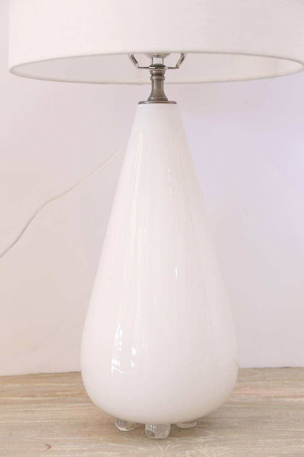 White glass table lamp from hand-blown cased-glass footed vase. This custom lamp is newly-wired for use within the USA and includes a complementary paper shade (lamp measurements include the shade).

 