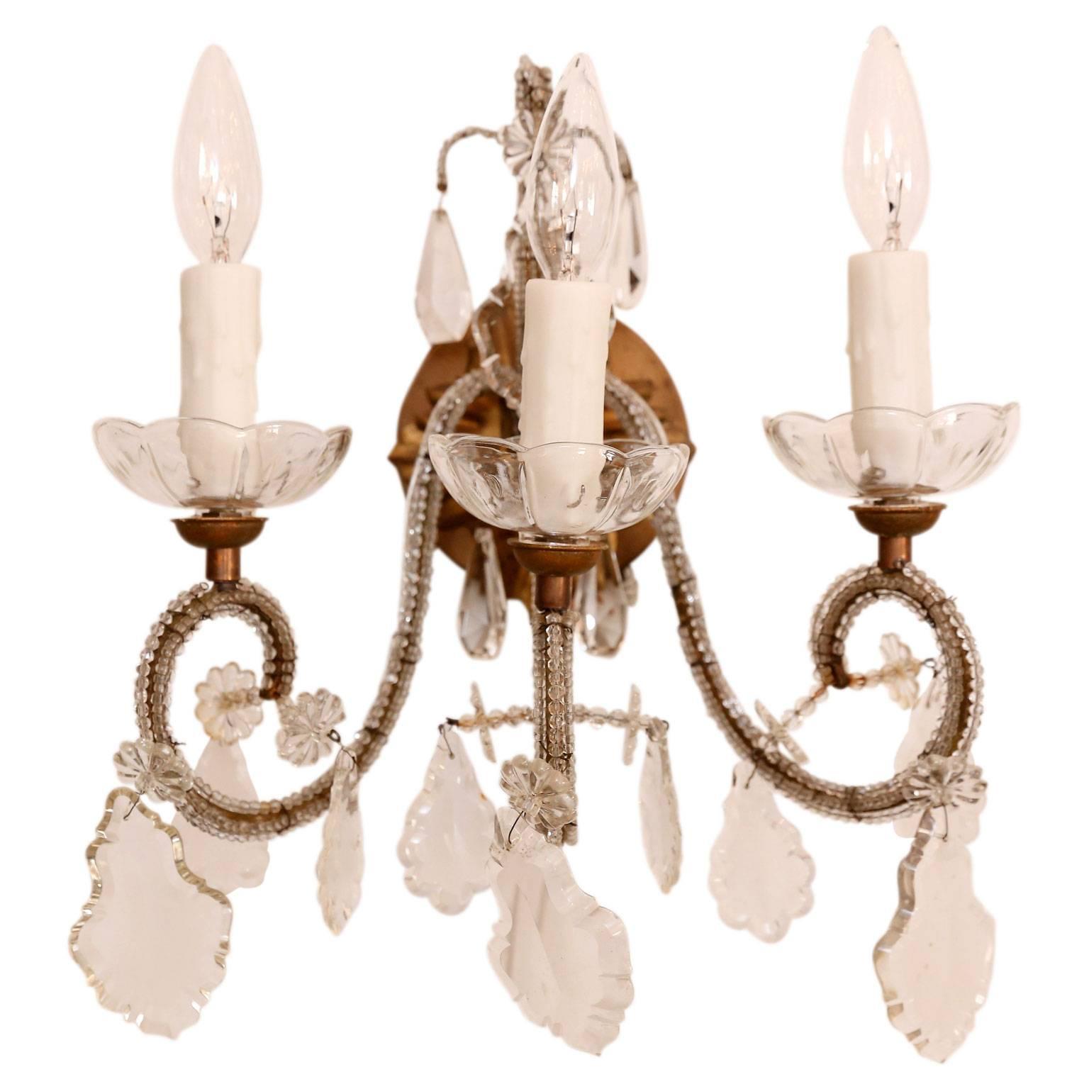 Set of four vintage gilded iron sconces from Italy, with three beaded arms each and cut crystal prism pendants. Newly-wired to UL standard. Can be sold as two pairs at $4,200 per pair.