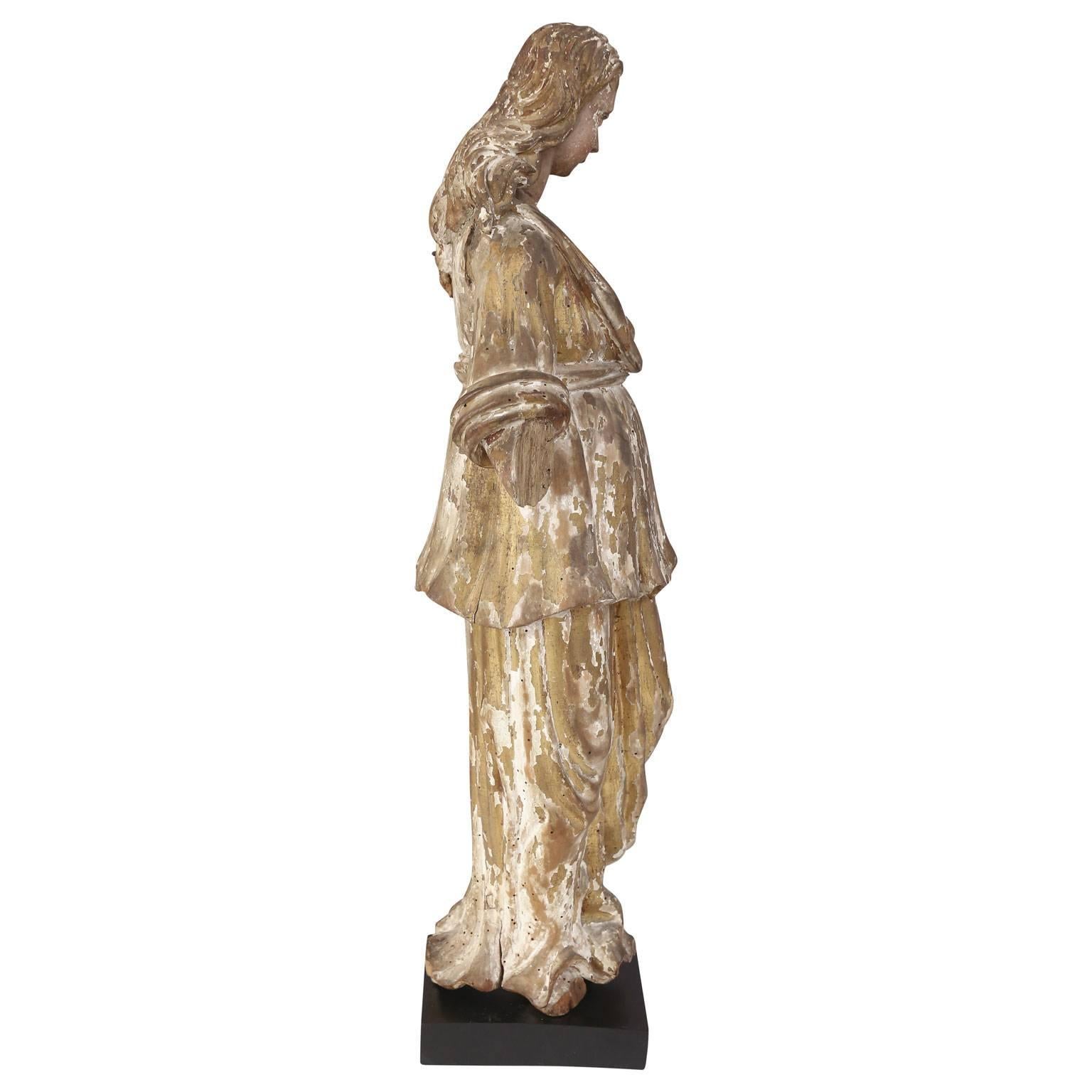 Early hand carved Italian statue of saint (or santo), circa 1690-1720. Covered in remnants of original polychrome paint and gilt finish. Nice height, size and graceful lines.
  