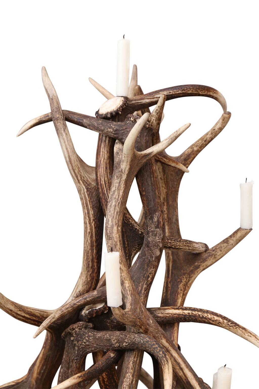 Naturally shed red stag antler tree-shape candelabra. Tree has metal prickets for candles (can also be electrified).