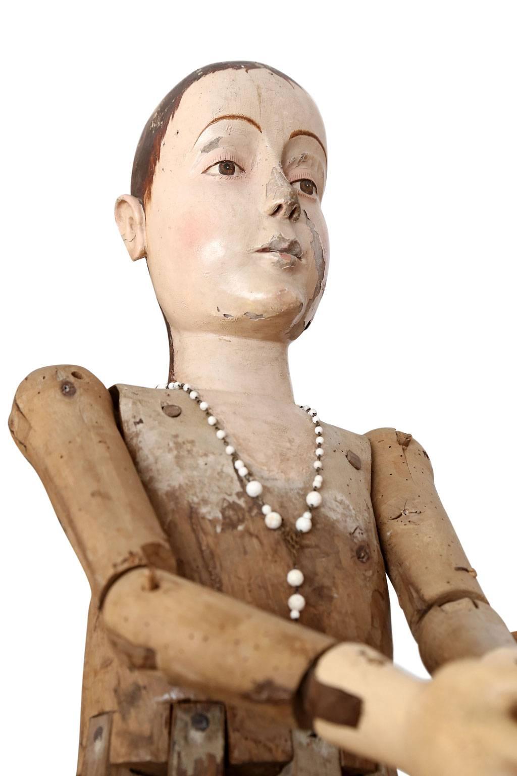 Large scale wooden French statue of saint, dated to the early 19th century. Hand carved polychrome head, torso and hands raised upon a cage-style lower body. Articulated arms can be adjusted for various poses. Mortise and Tenon construction. Solid