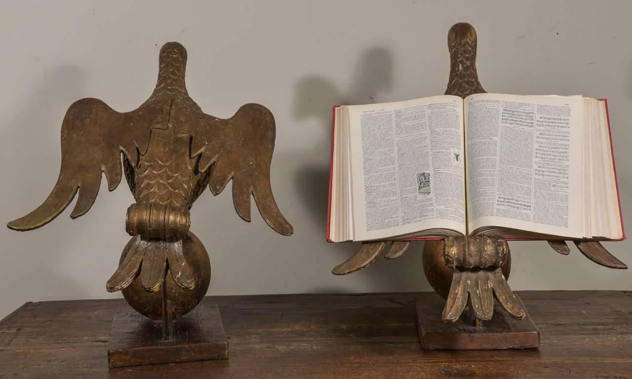 Pair of early giltwood book stands carved as doves mounted upon orbs, from the late 17th or early 18th century. Nice large scale. Books are laid open across the backs of the doves' wings, supported by the giltwood scrolled element atop the doves'