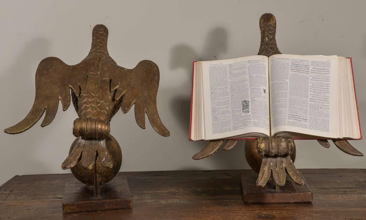 Paire de porte-livres en bois doré sculpté de colombes montées sur des orbes, de la fin du XVIIe ou du début du XVIIIe siècle. Belle échelle. Les livres sont posés ouverts sur le dos des ailes des colombes, soutenus par l'élément à volutes en bois