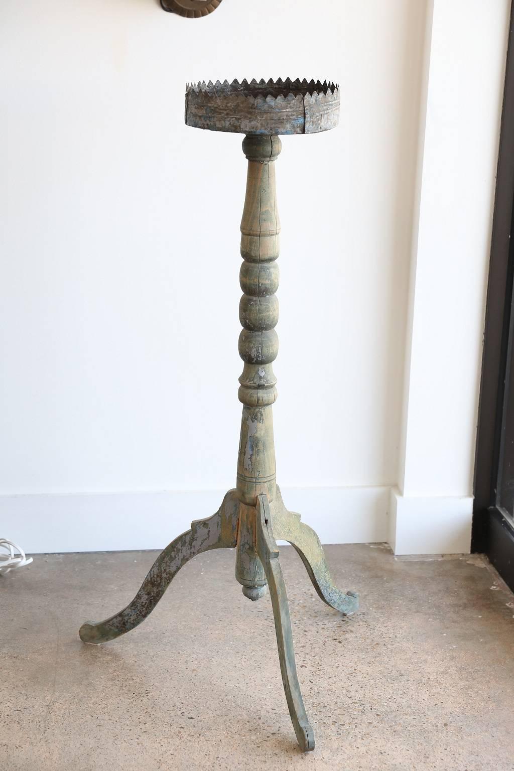 18th century painted turned wood candle stand with decorative tole drip pan and scrolled leg base.