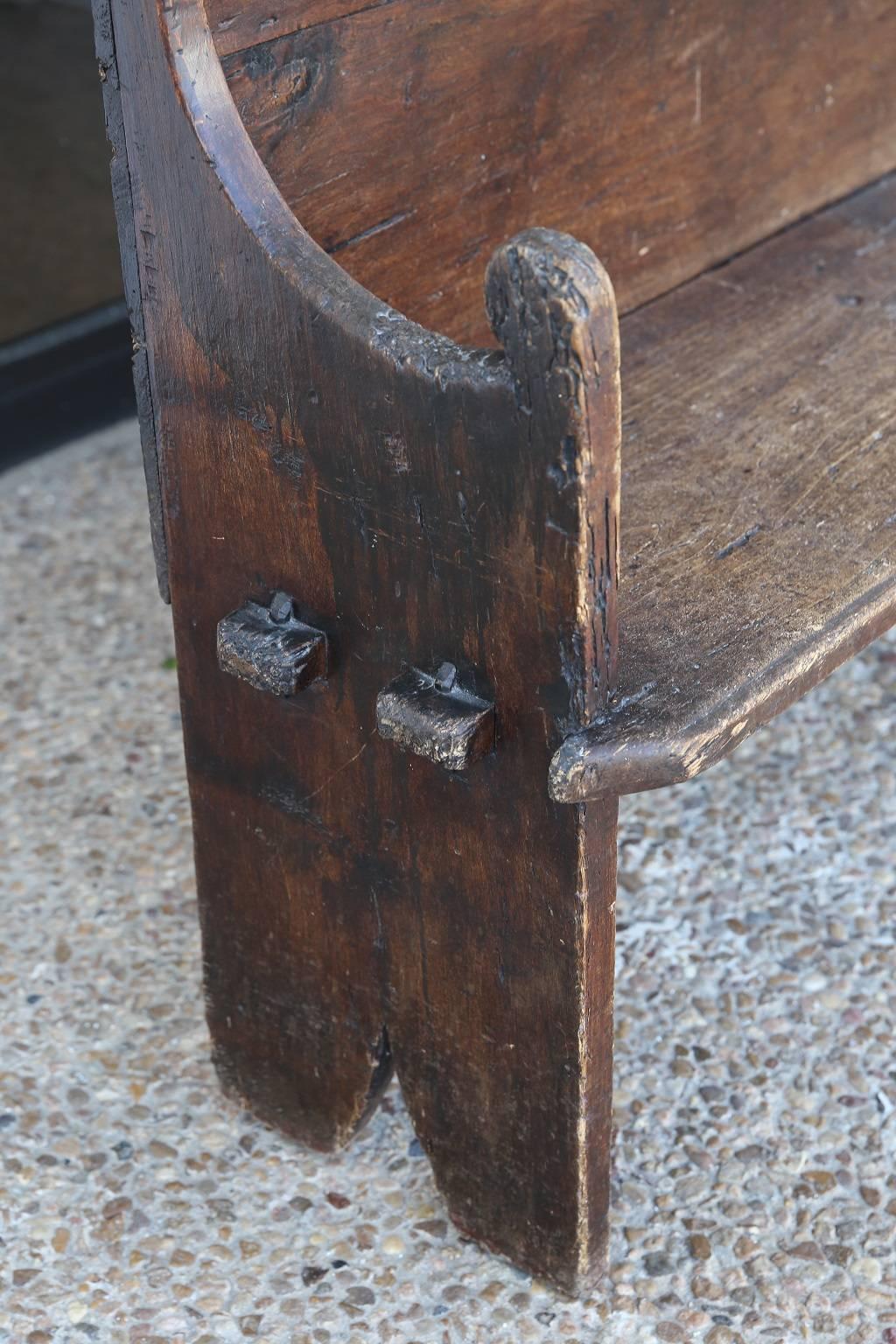 Early 18th century chestnut bench, from Northern Italy, with pegged-construction and scalloped back.