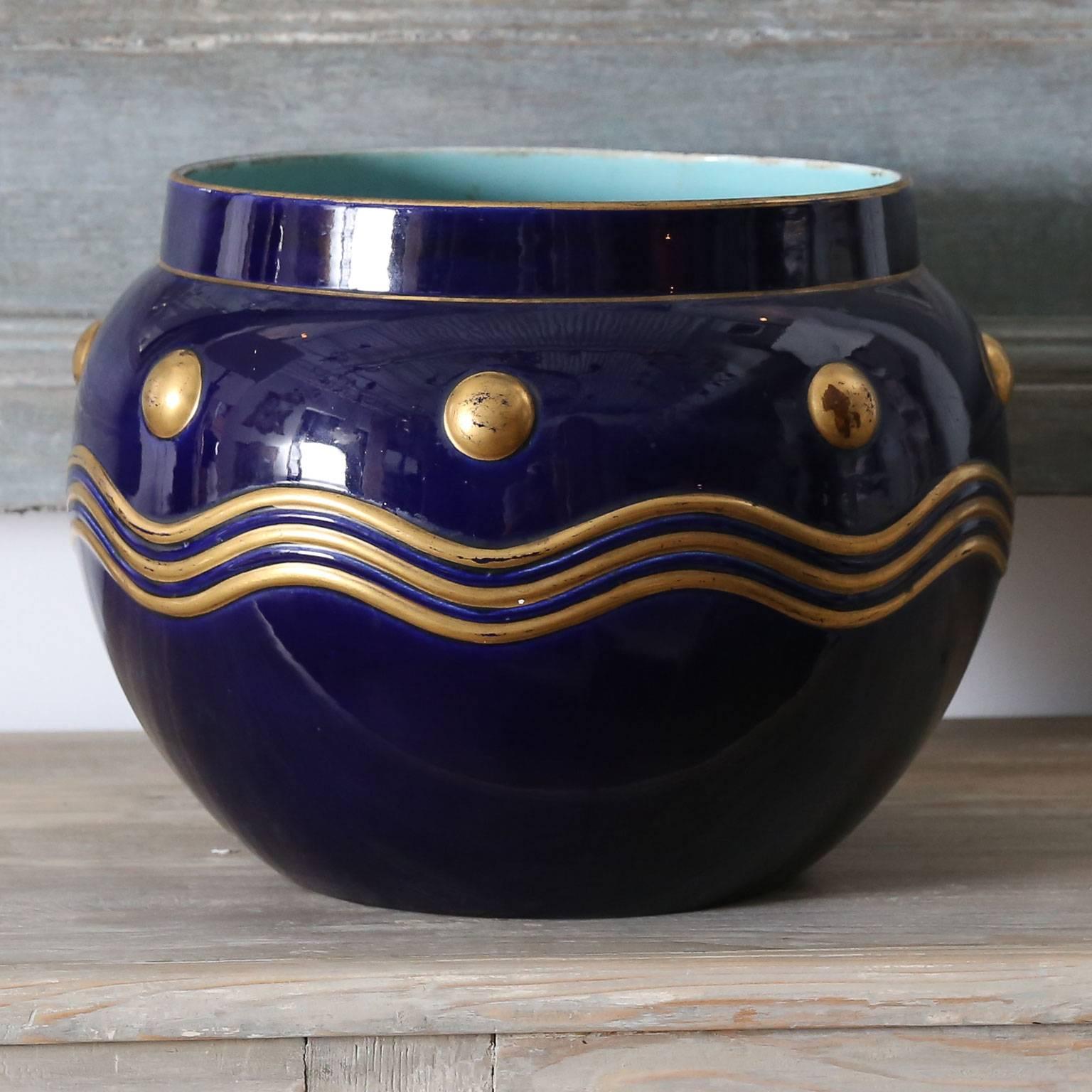 French faience cachepot by Sarreguemines - Digoin - Vitry-le-François (formerly Utzschneider & Cie of Sarreguemines, France). Cobalt blue surface adorned with raised gilt decoration. Interior and bottom surfaces of cachepot are finished in a soft,