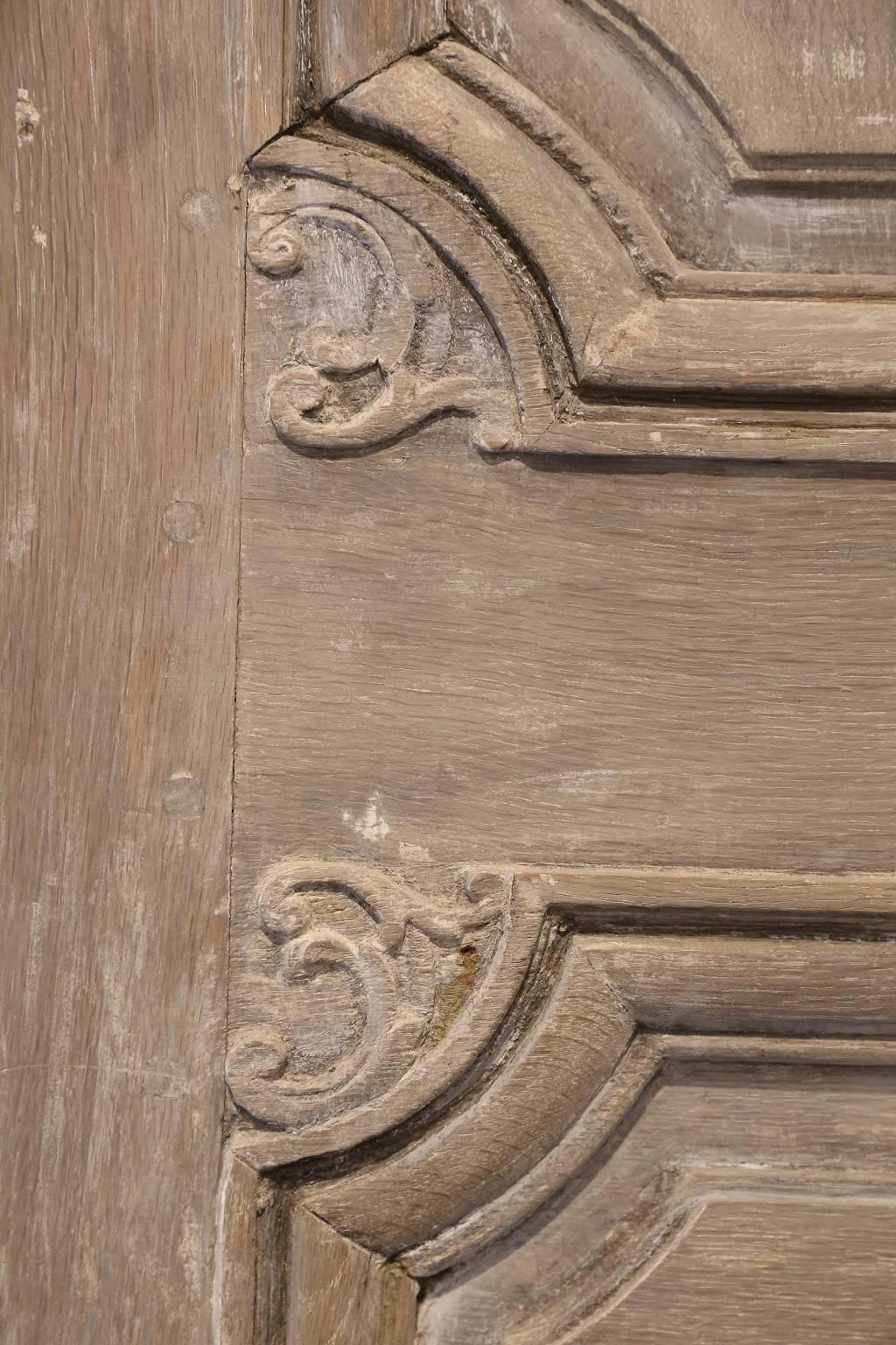 18th century Italian doors, large scale and beautifully hand-carved circa 1780-1800. Subtle remnants of old paint, beautiful patina and original hinges, restored working lock and new 18th century style key.

The left door measures 29 inches wide and