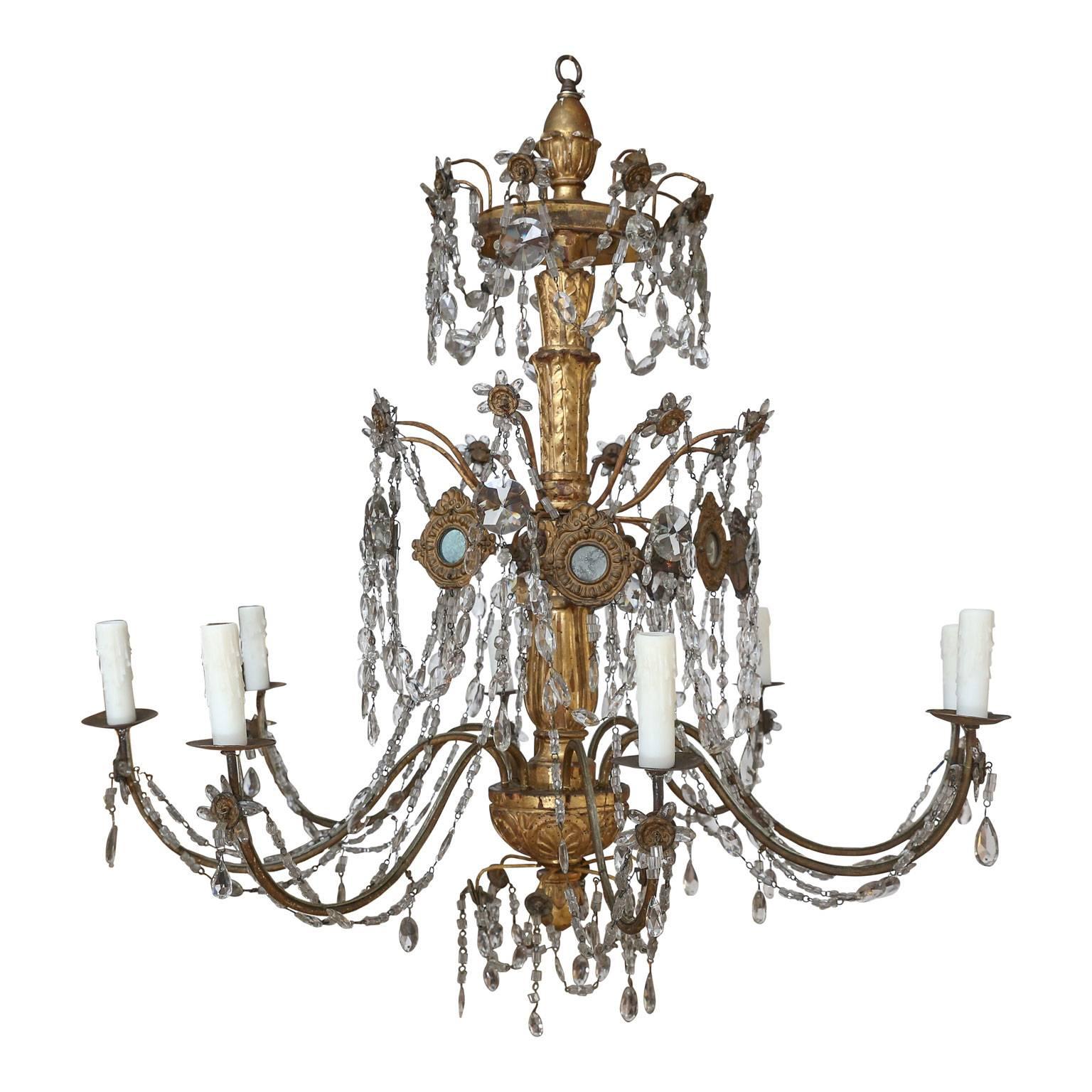 Pair of 18th century Genoese chandeliers with original arms, mirrored bronze reflectors and decorated with most of their original crystal and gilded finish (with some loss of gilding and restoration). A beautiful pair in this shape and condition is