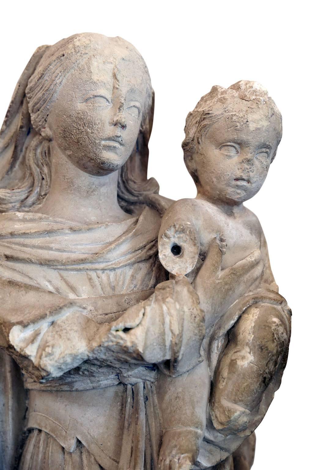 Large French limestone statue of mother and child (circa 1615-1635) from Ardeche in the Auvergne-Rhône-Alpes region of south-central France.