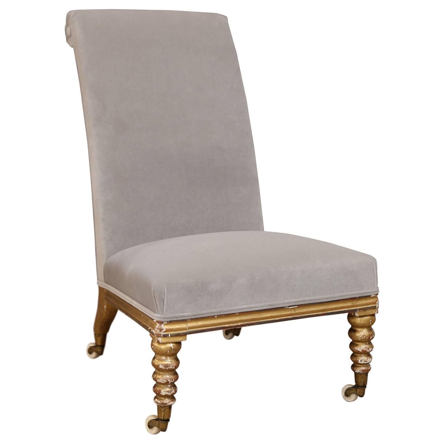 Irish gilt side chair with carved legs on original casters (front legs bobbin), and intact (and reworked) original webbing and horsehair upholstery, newly covered in gray velvet. Dated to the early 19th century with maker's label under seat (seat