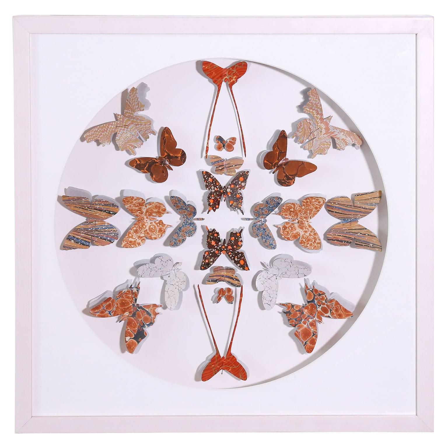 Marbled end paper of various designs and colors, from antique books, cut into butterfly shapes and pinned in a circular formation within four framed shadowboxes. Frames are white-washed maple.  Three sold - remaining butterfly box may be seen as