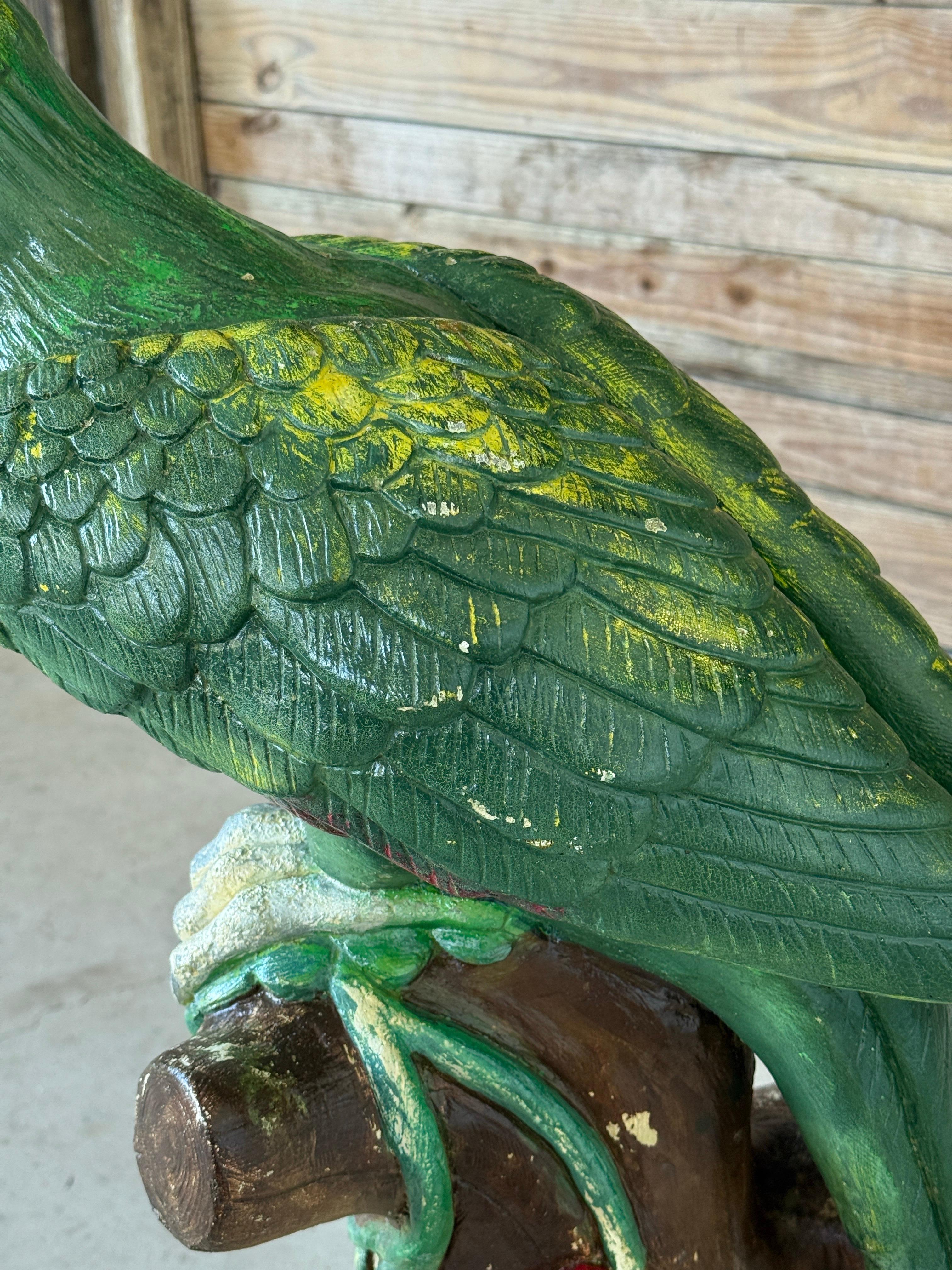 Make a bold Old Florida statement with this monumental vintage parrot garden statue, beautifully hand-painted and full of character. Sculpted in cast concrete, this tropical treasure is perched on a tree stump adorned with floral and vine detailing.