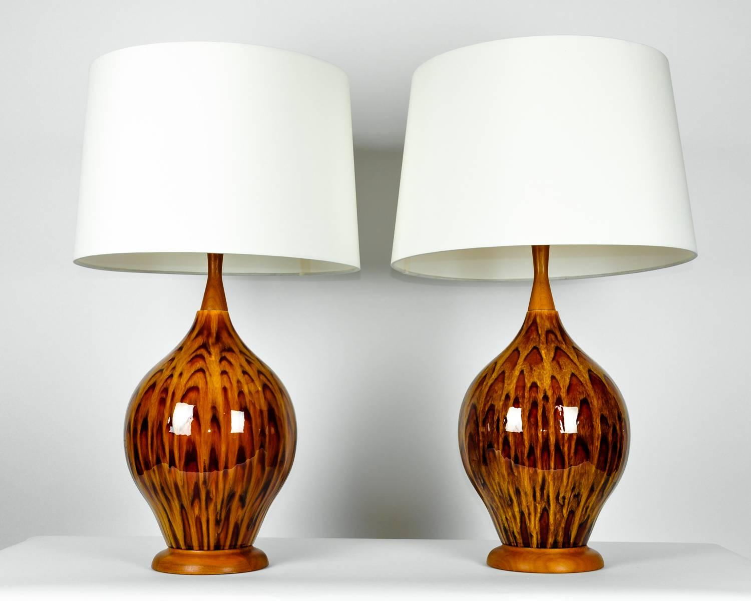Vintage Italian glazed porcelain pair table lamps. Each lamp is in excellent working condition. Each lamp measure 31 inches high x 11 inches diameter. Rewired for US use, each lamp comes with a round drum silk exterior shade measure 12