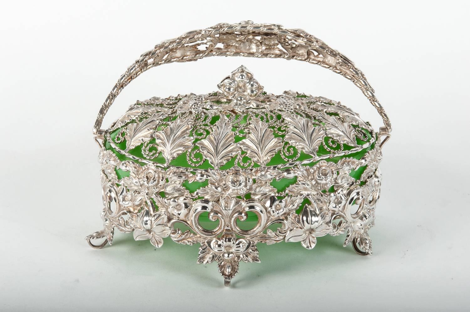 Antique English silver plated basket dish with celadon glass insert. The piece is in excellent antique condition. The dish measure 6.5 inches high X 7 inches diameter.