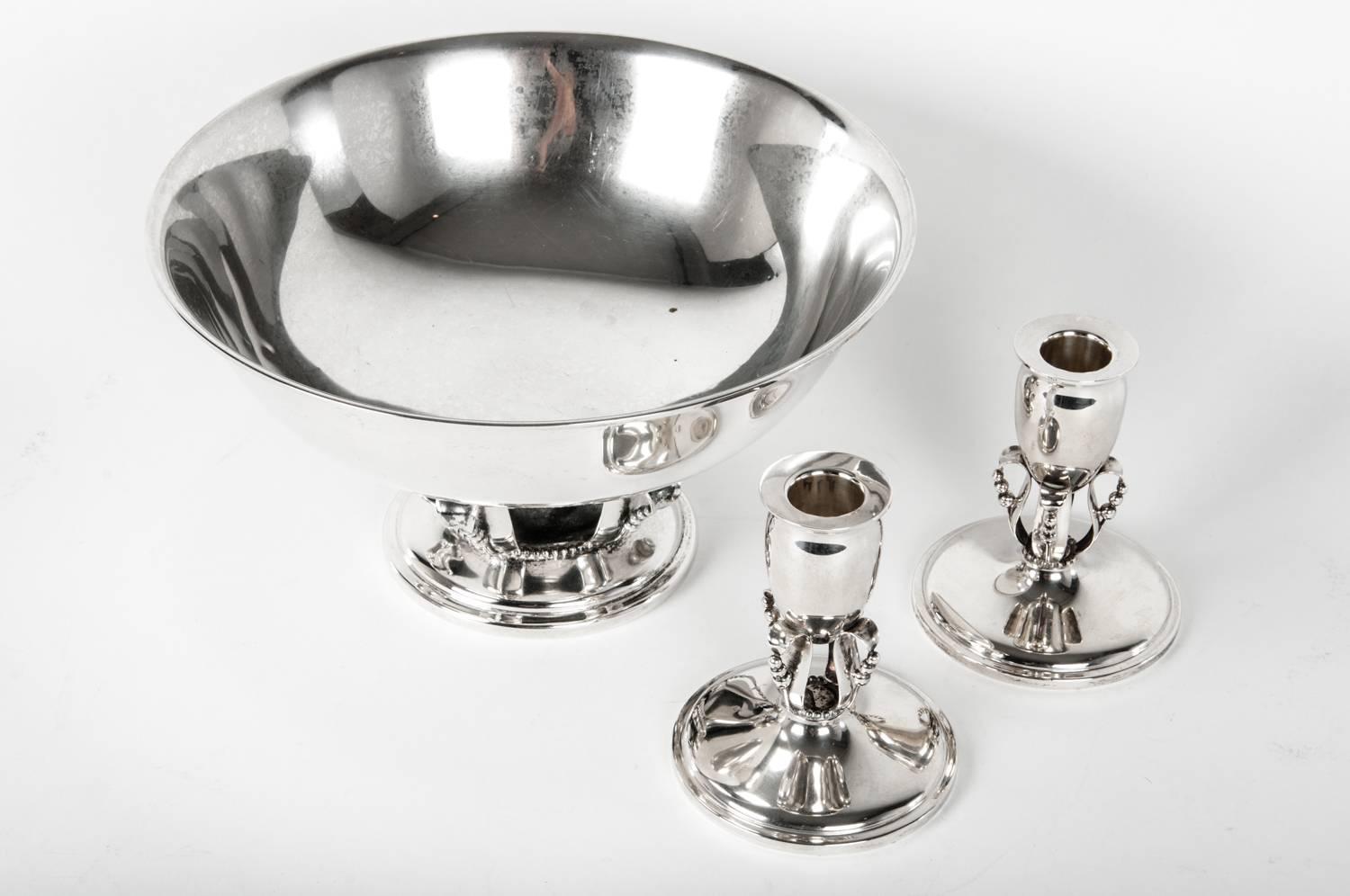 Sterling silver Mid-Century footed center piece bowl with two candle sticks. Each piece is undersigned and numbered . Each one is in excellent condition. These pieces would bring a great addition to any table, side board or mantel. The footed bowl
