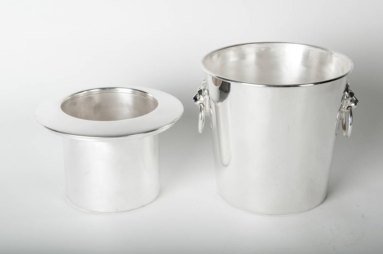 Vintage English silver plated wine cooler / ice bucket with two side handles. The wine cooler / ice bucket is in excellent vintage condition, maker's mark undersigned . The cooler / ice bucket measure about 9 inches diameter x 7.5 inches height.
