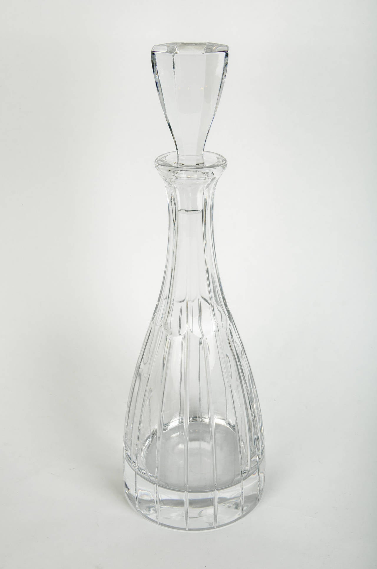 Vintage cut crystal Art Deco style drinks decanter with cut crystal lid. The decanter is in excellent vintage condition, this would bring a great addition to any bar or table. The decanter measure about 14 inches with topper and 5 inches diameter.